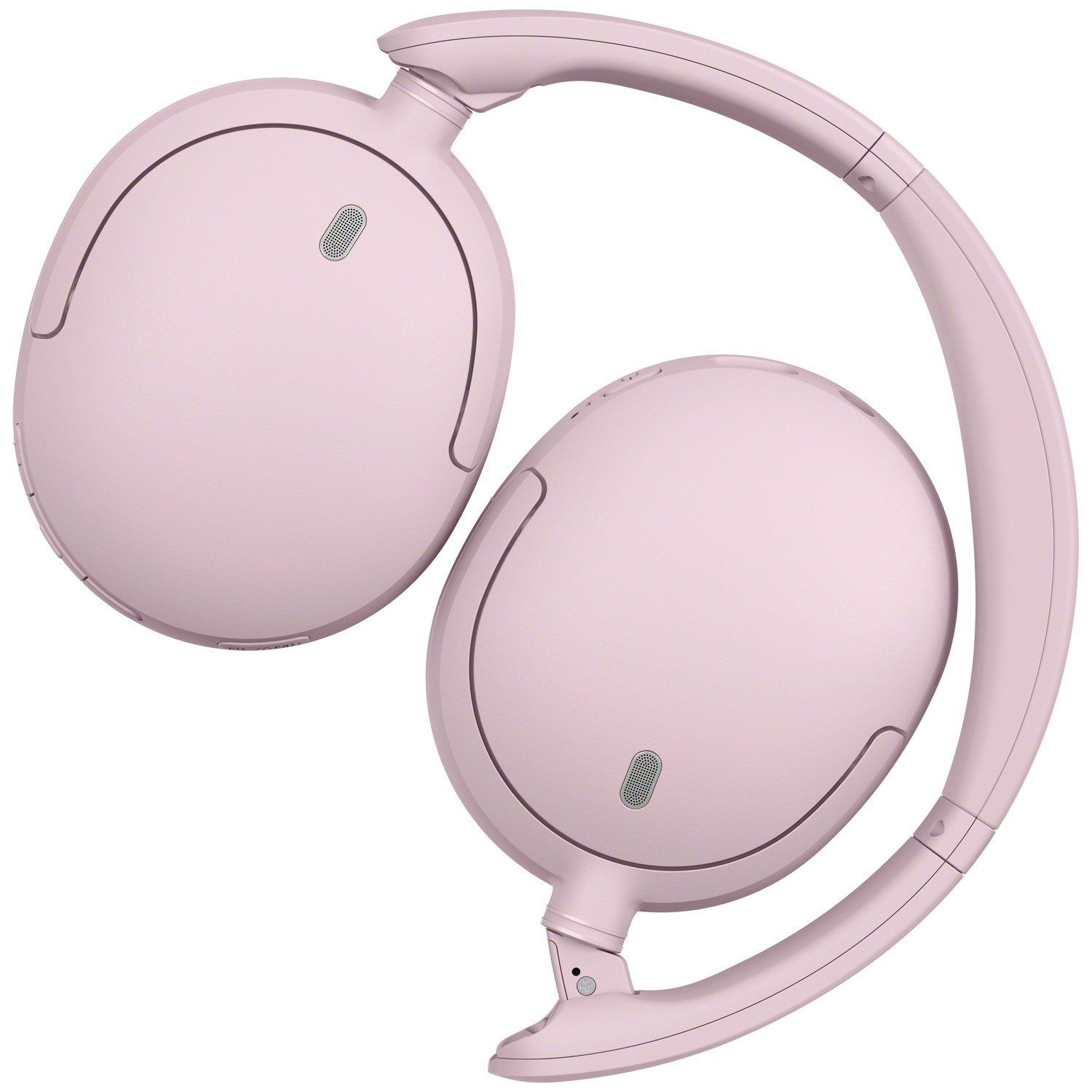 Casque sans fil supra-auriculaire rose clair au design élégant et oreillettes visibles sur fond blanc.