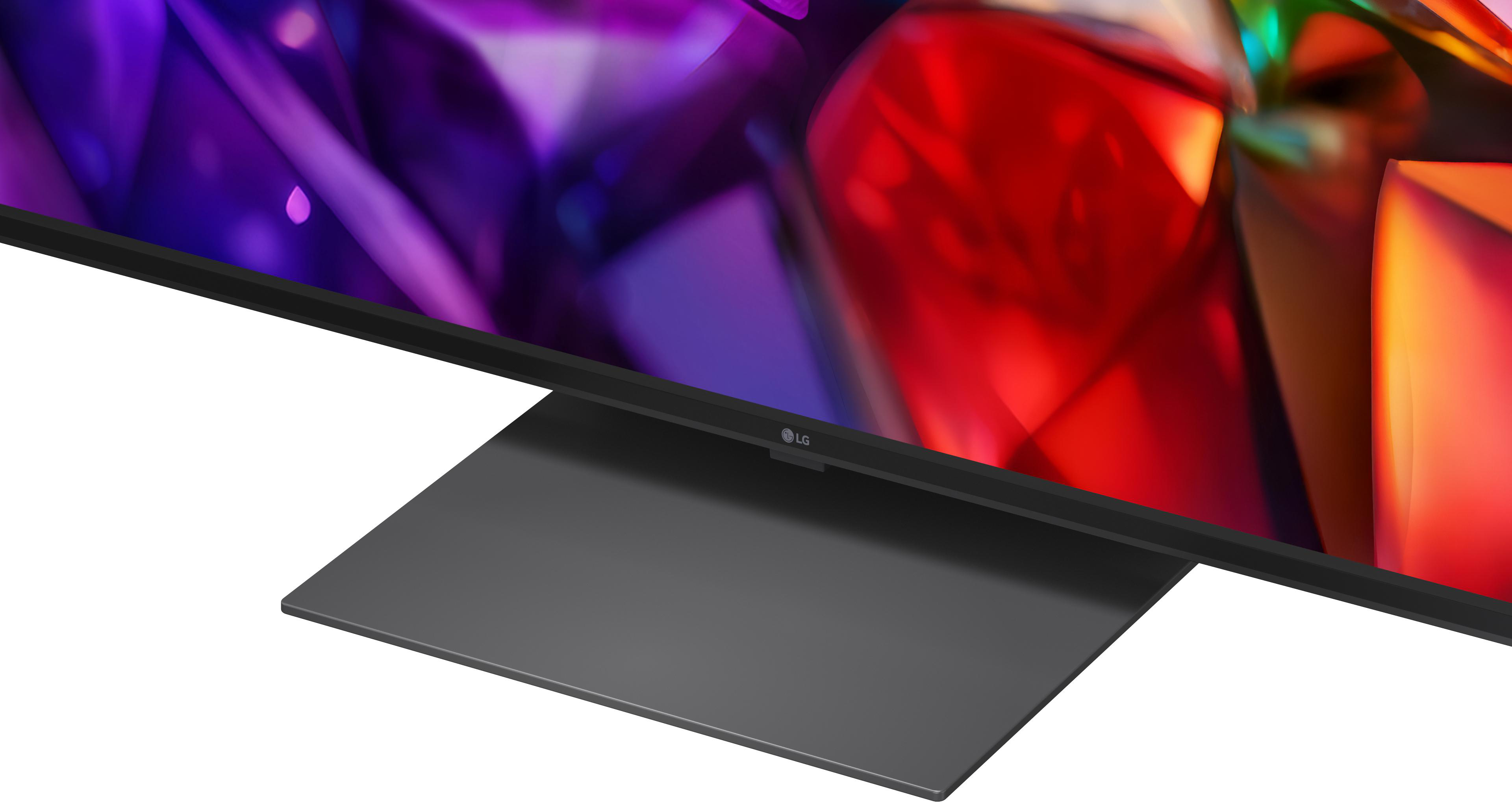 Nahaufnahme eines LG-Fernsehers mit einem bunten Bildschirm und einem grauen Standfuß.