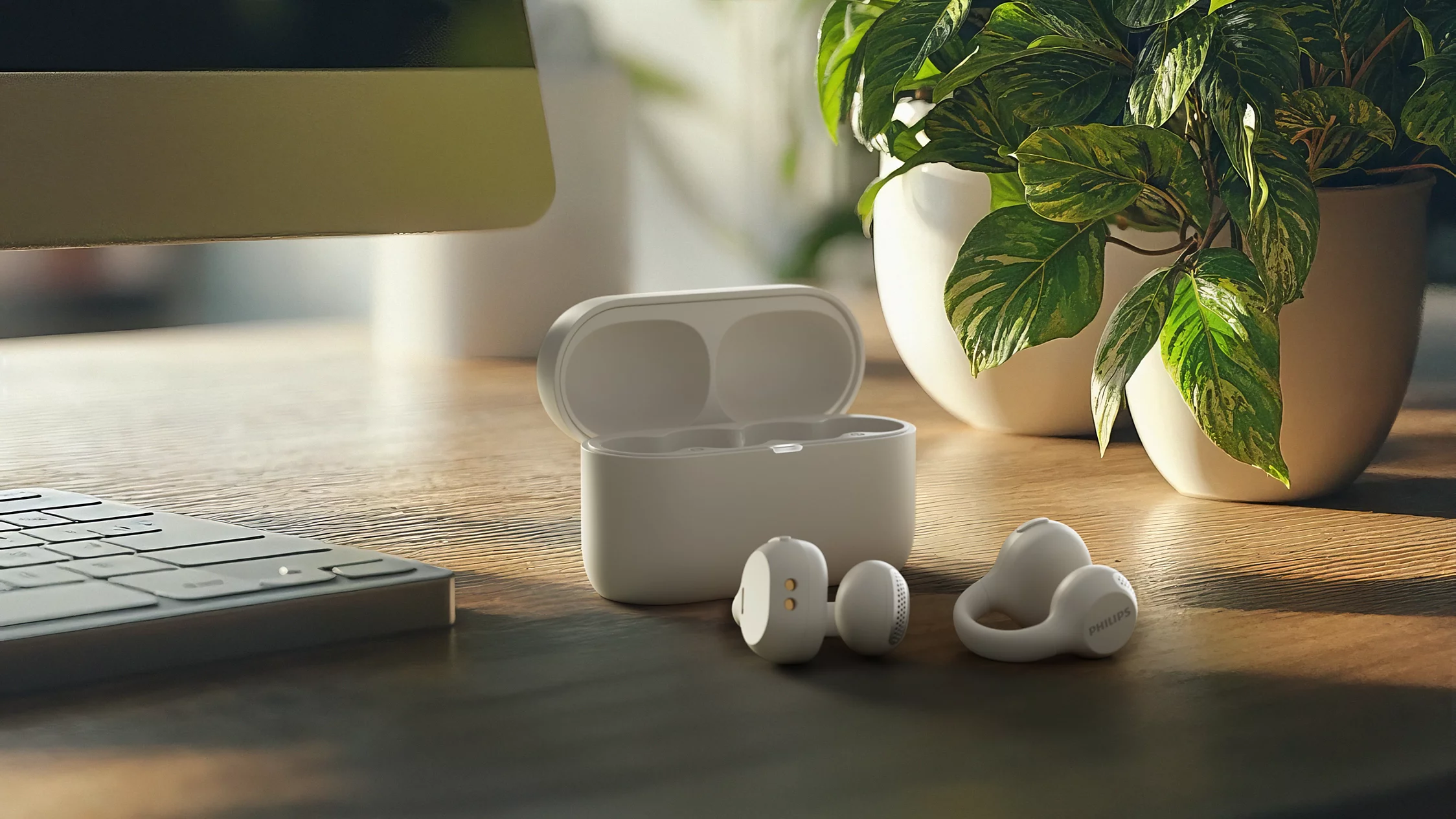 Écouteurs sans fil blancs et étui de charge sur un bureau en bois près de plantes.