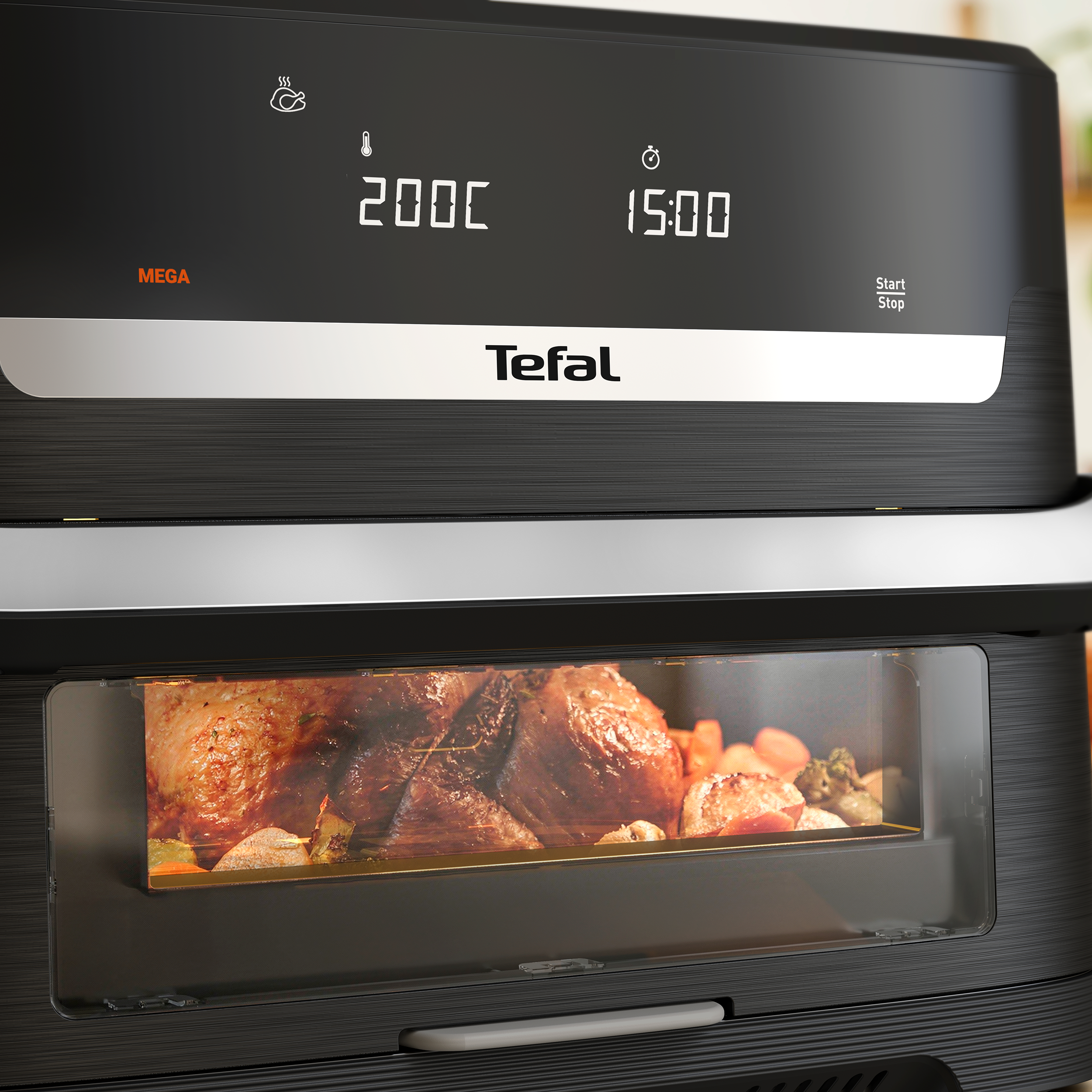 Fekete Tefal forrólevegős fritőz 200°C-ot és 15 percet mutató digitális kijelzővel, az ablakon át látható csirkével.