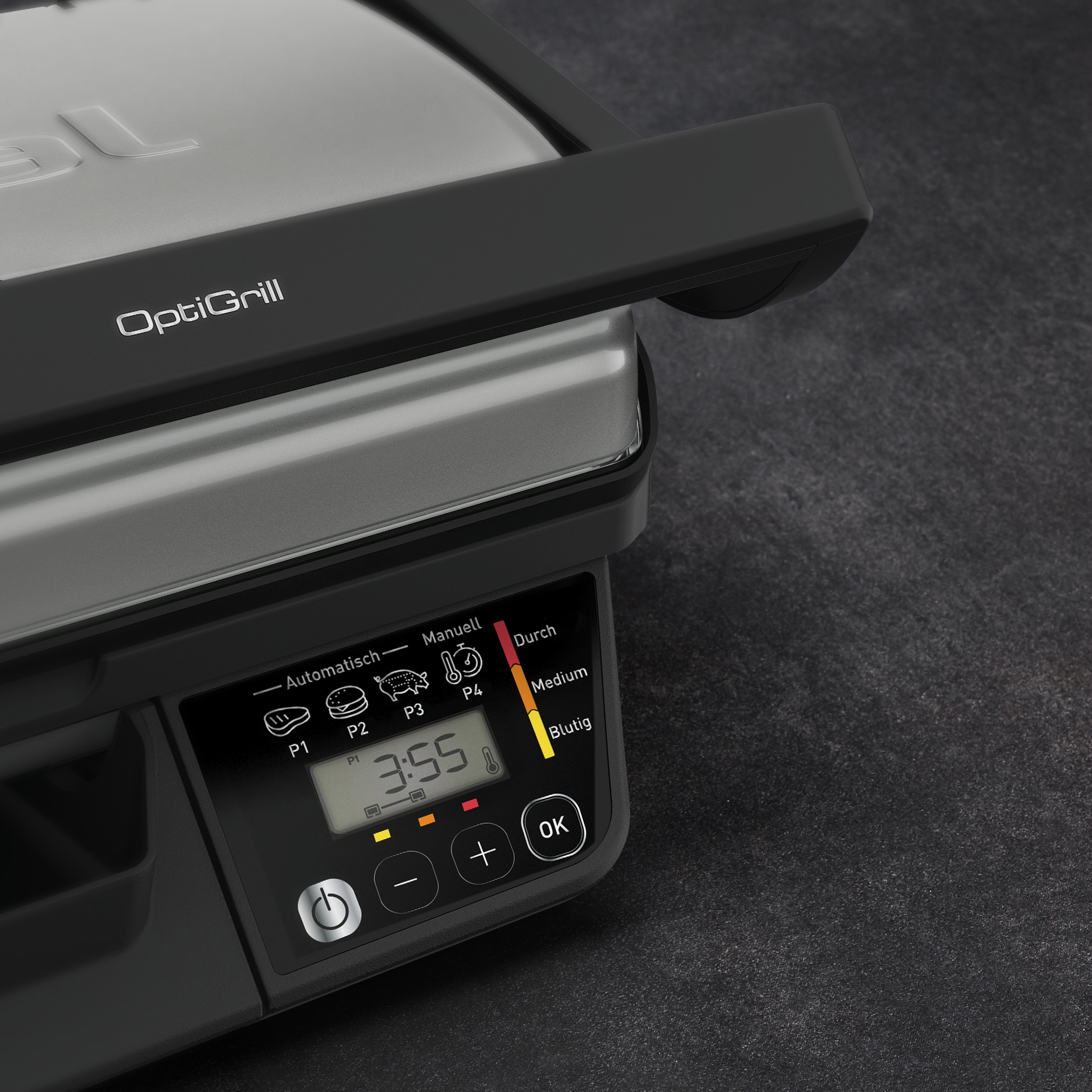 OptiGrill digitális kijelzővel és főzési programokkal sötét asztalon.