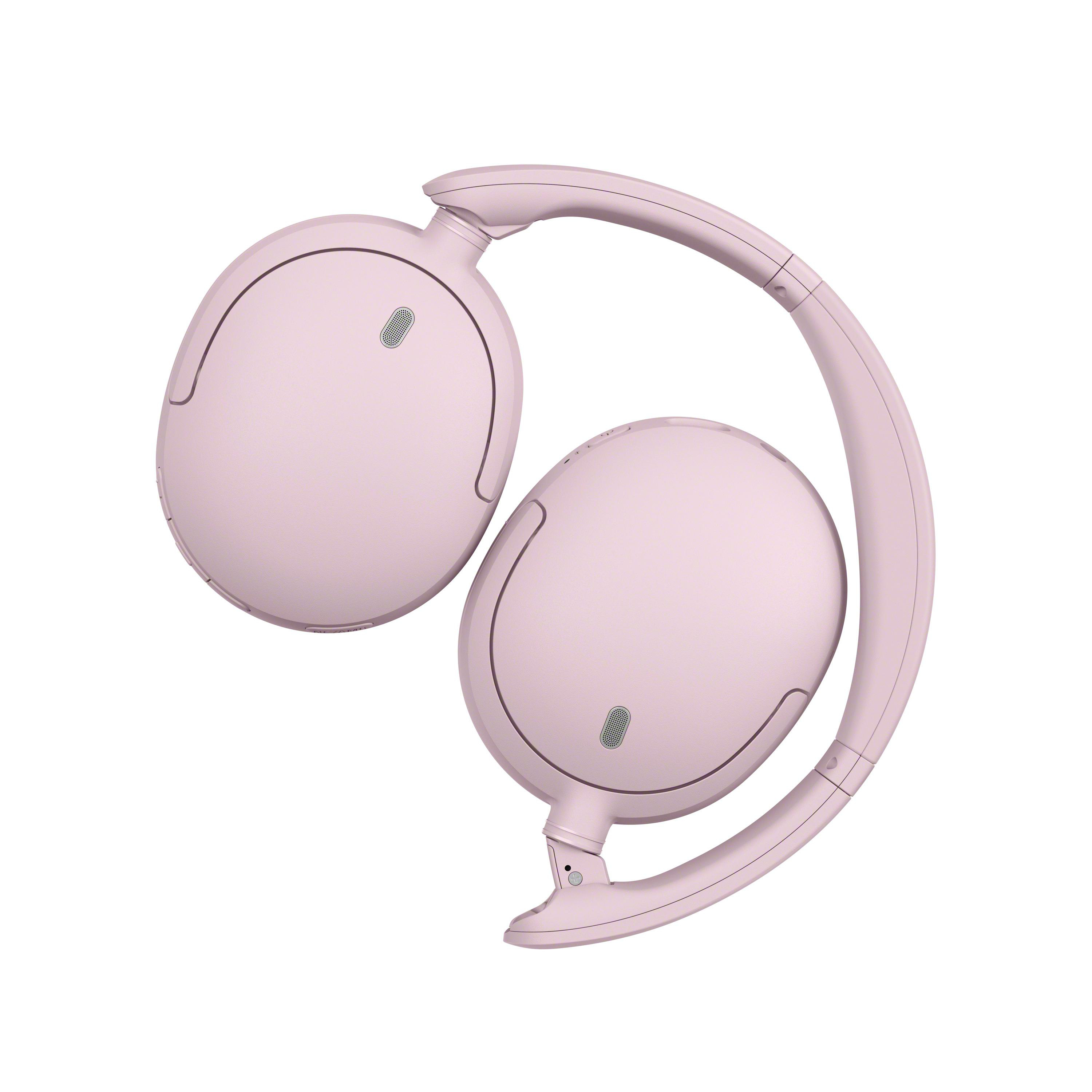 Moderne, hellrosa kabellose Over-Ear-Kopfhörer vor einem weißen Hintergrund.