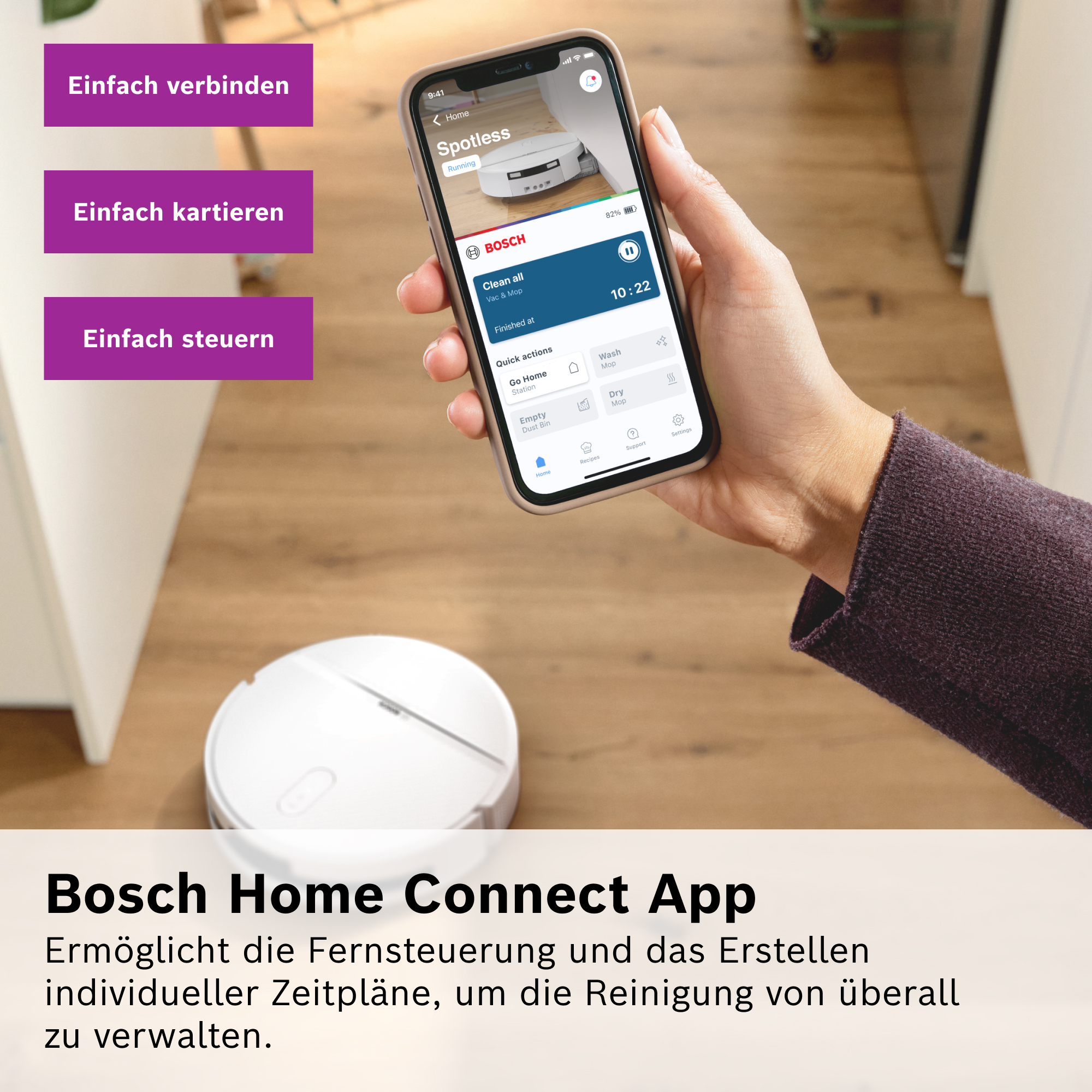Hand hält Smartphone mit Bosch Home Connect App, während ein weißer Saugroboter auf einem Holzboden steht.