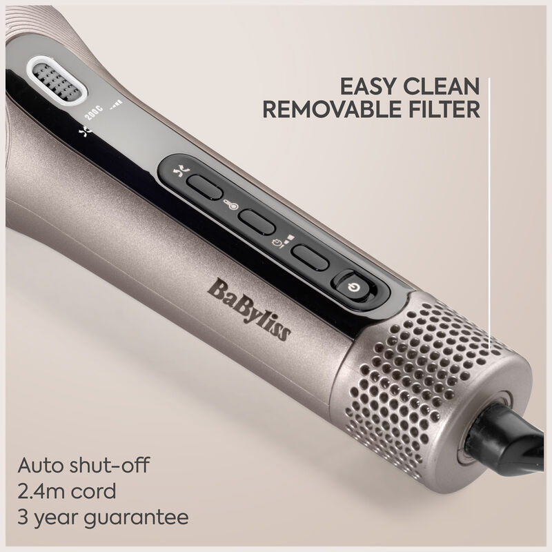 Gros plan sur la poignée d'un sèche-cheveux BaByliss rose gold, montrant les boutons et le filtre amovible.