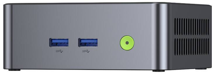 Egy kompakt szürke mini PC elülső nézete két kék USB-porttal és egy kerek zöld bekapcsológombbal.