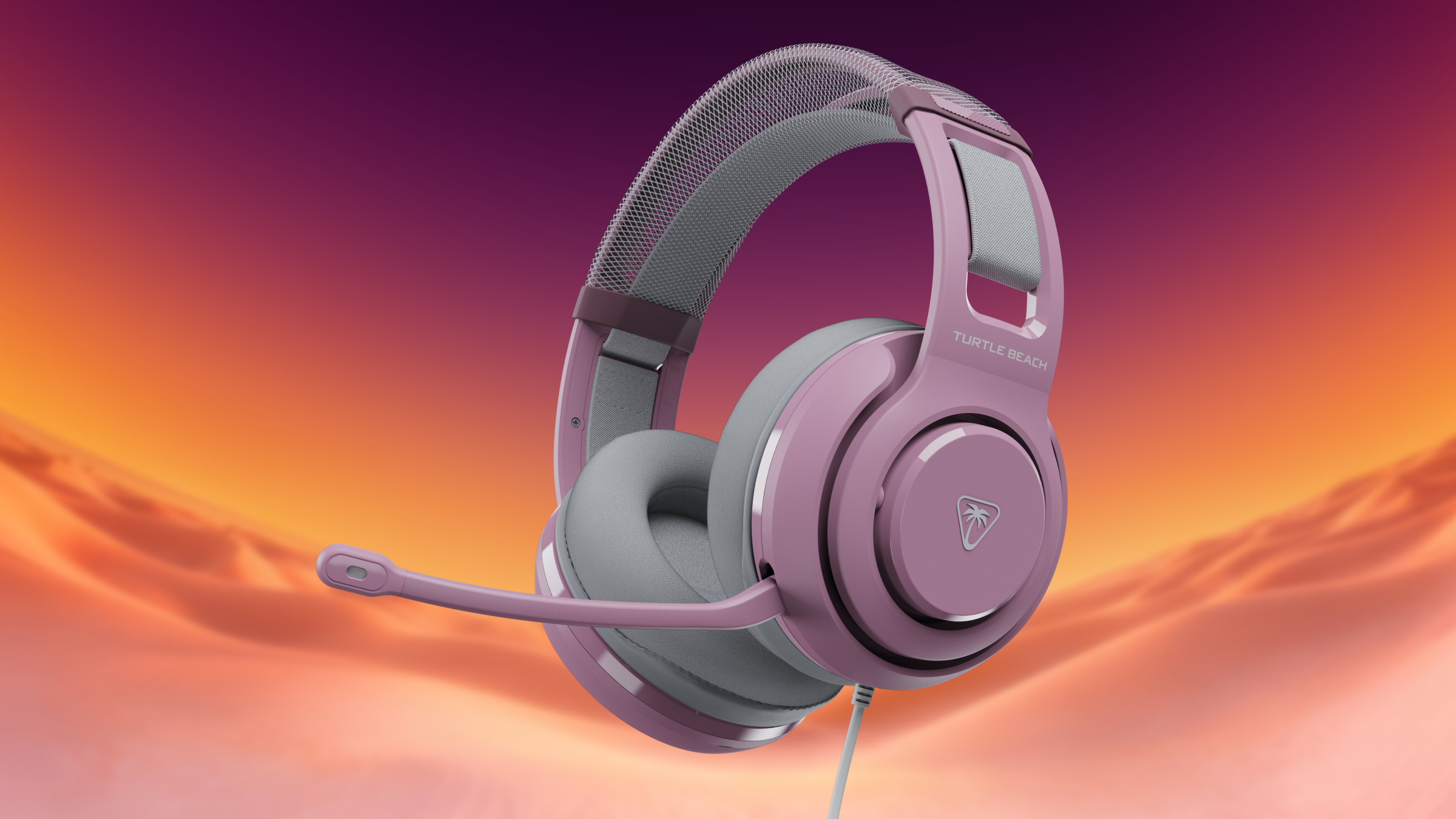 Pink and grey Turtle Beach gaming headset with microphone against an orange and purple background.