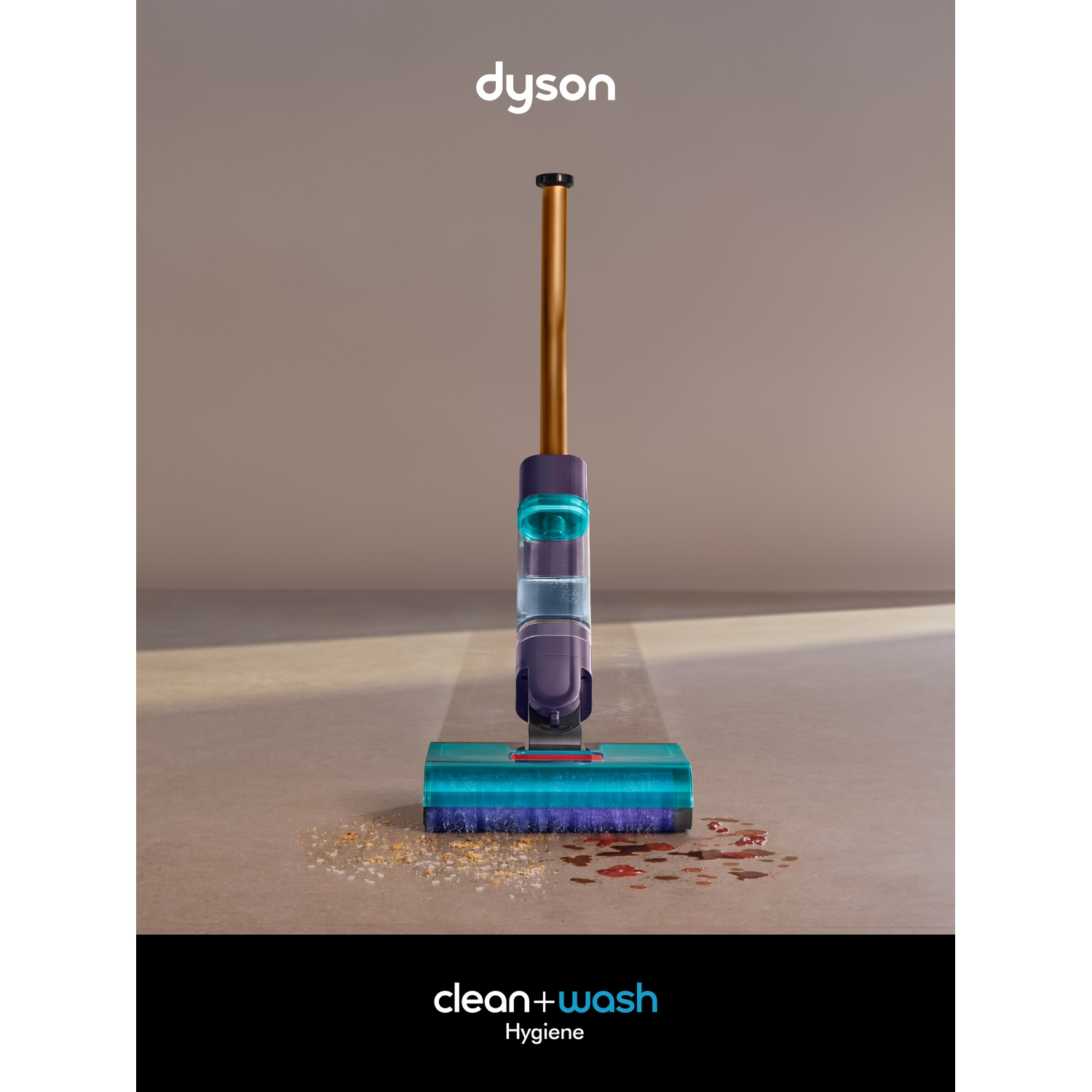 Un appareil Dyson clean+wash se tient sur un sol sale avec des miettes et des taches.