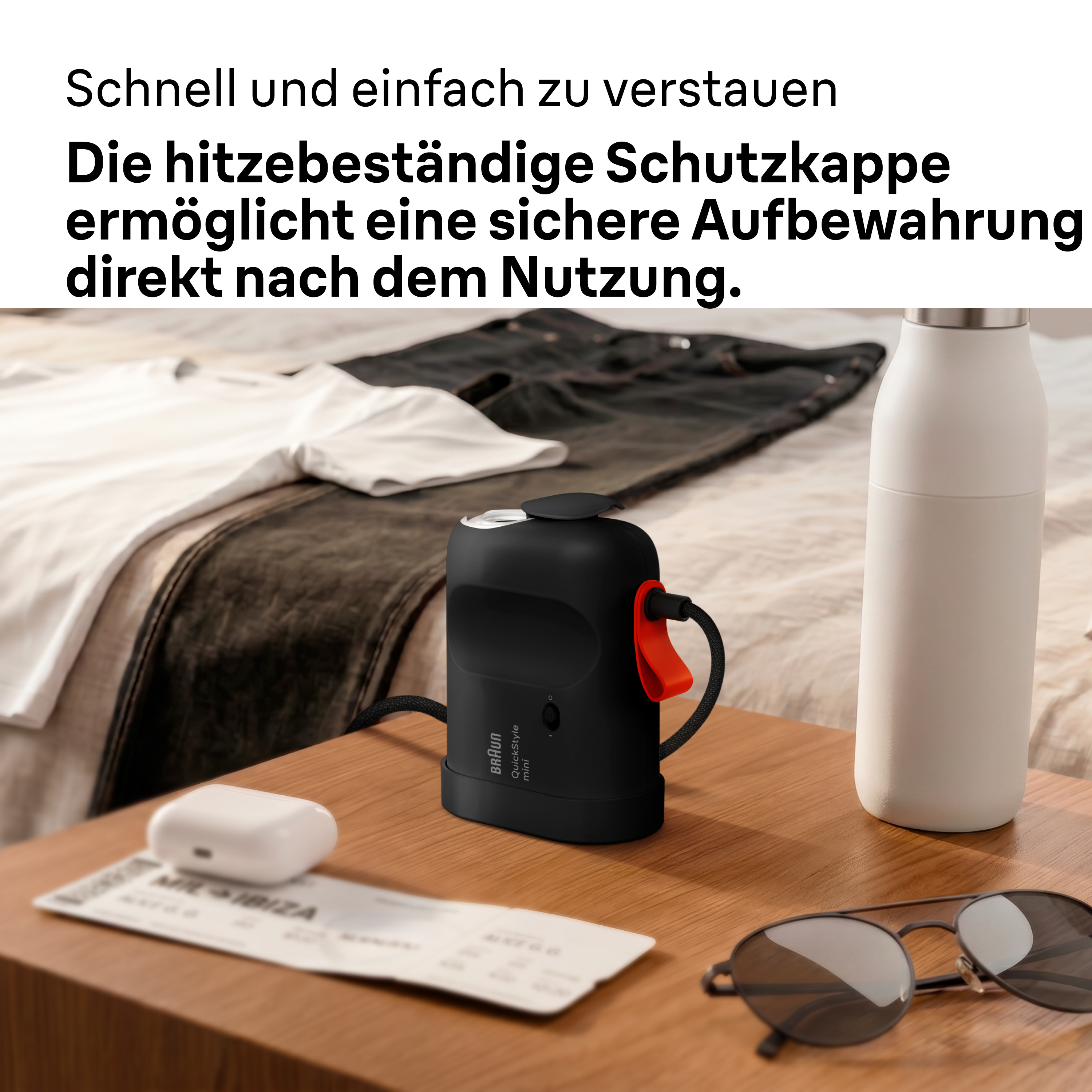 Ein schwarzer Braun QuickStyle mini Steamer, eine Sonnenbrille und eine Wasserflasche auf einem Holztisch.