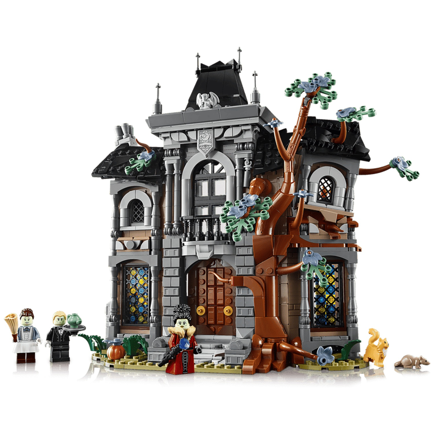 Spooky LEGO haunted mansion set with minifigures, a bare tree, and stained glass windows.