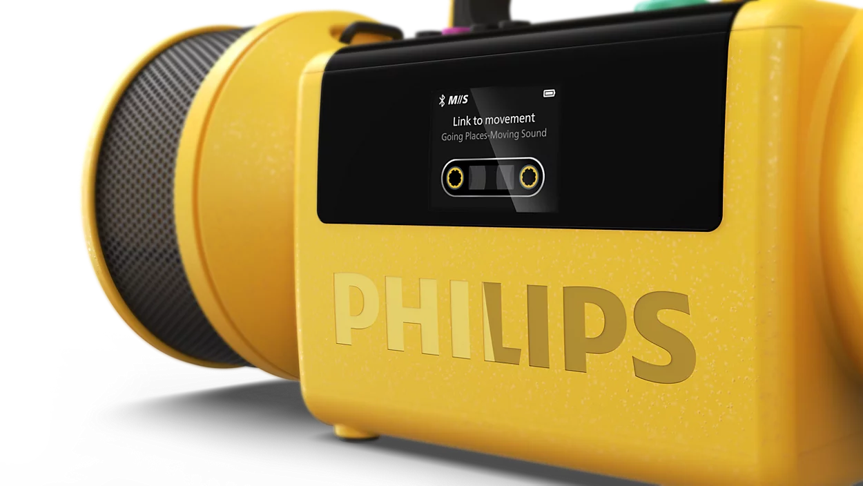 Sárga hordozható Philips hangszóró digitális kijelzővel fekete háttér előtt.