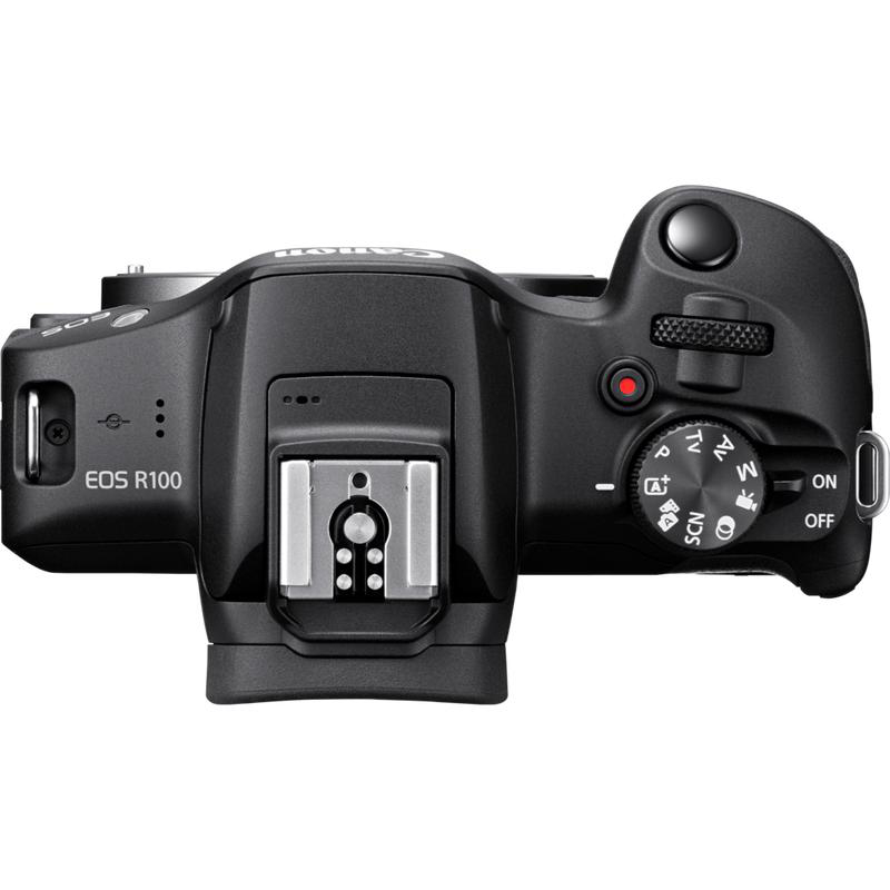 Oberseite einer schwarzen Canon EOS R100 Kamera mit Einstellrad, Auslöser und Blitzschuh.