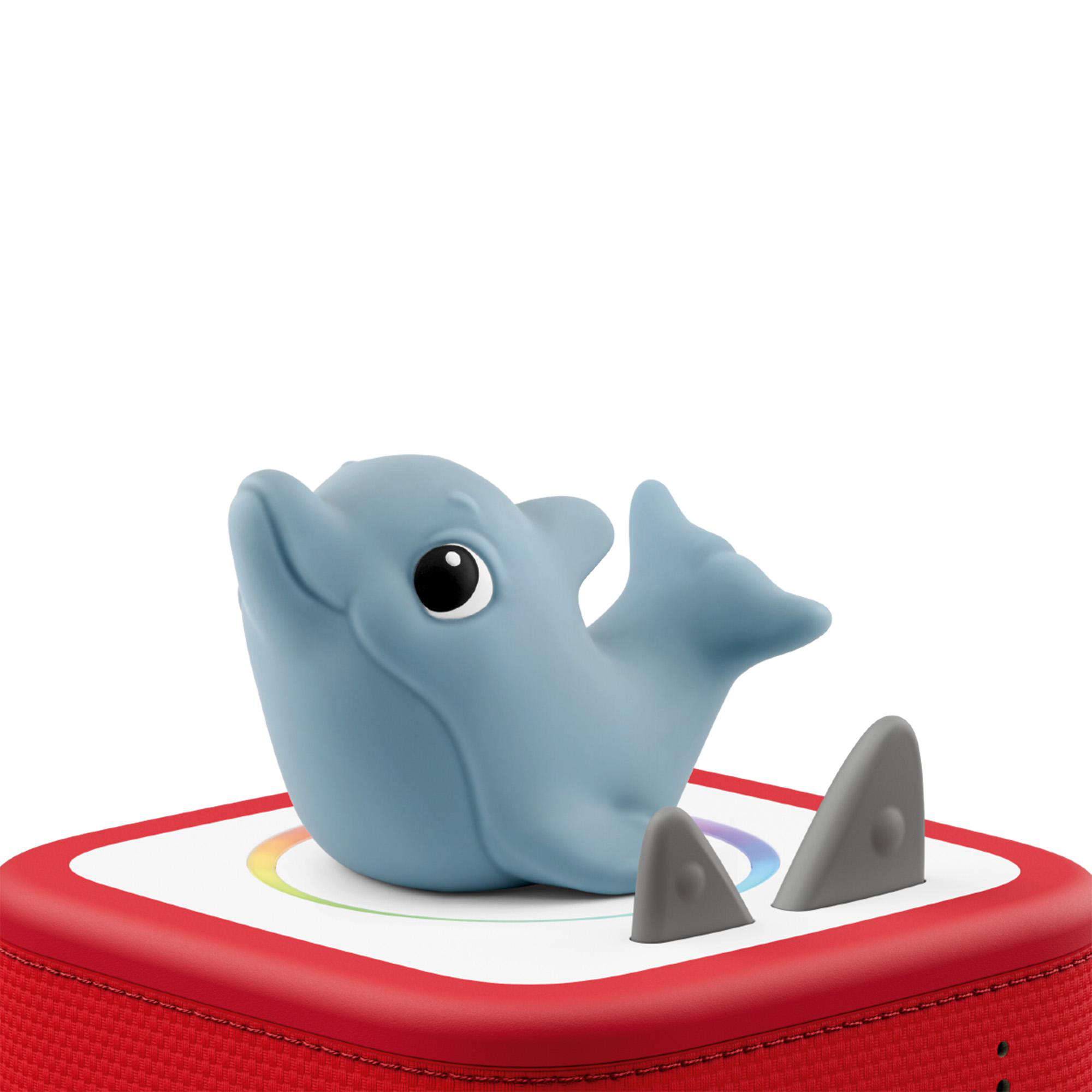 Ein blauer Delfin-Figur sitzt auf einem roten Lautsprecher mit einer bunten Kreisgrafik.