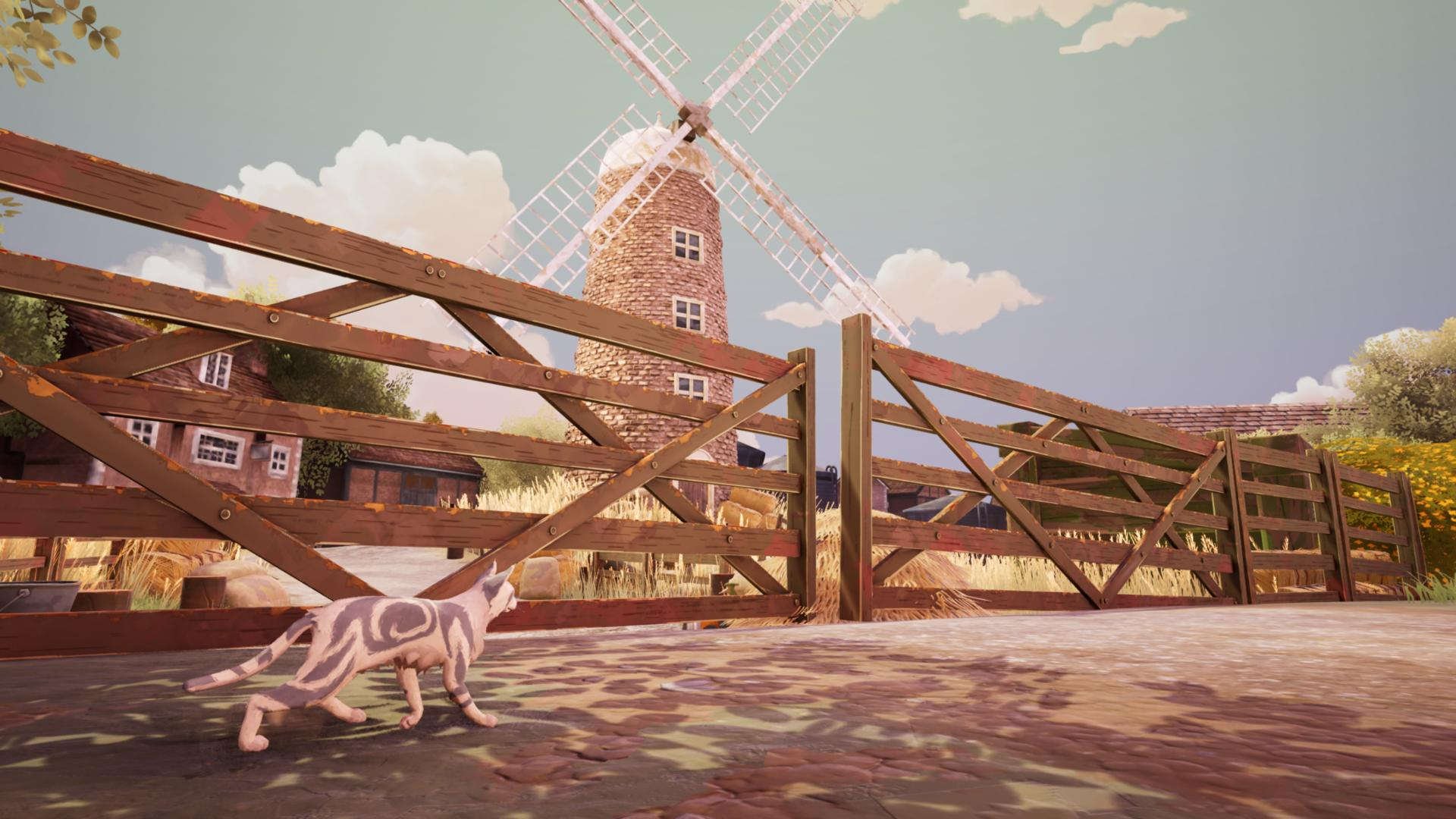 Eine graugestreifte Katze geht vor einem Holzzaun mit einer Windmühle und Farmgebäuden im Hintergrund.
