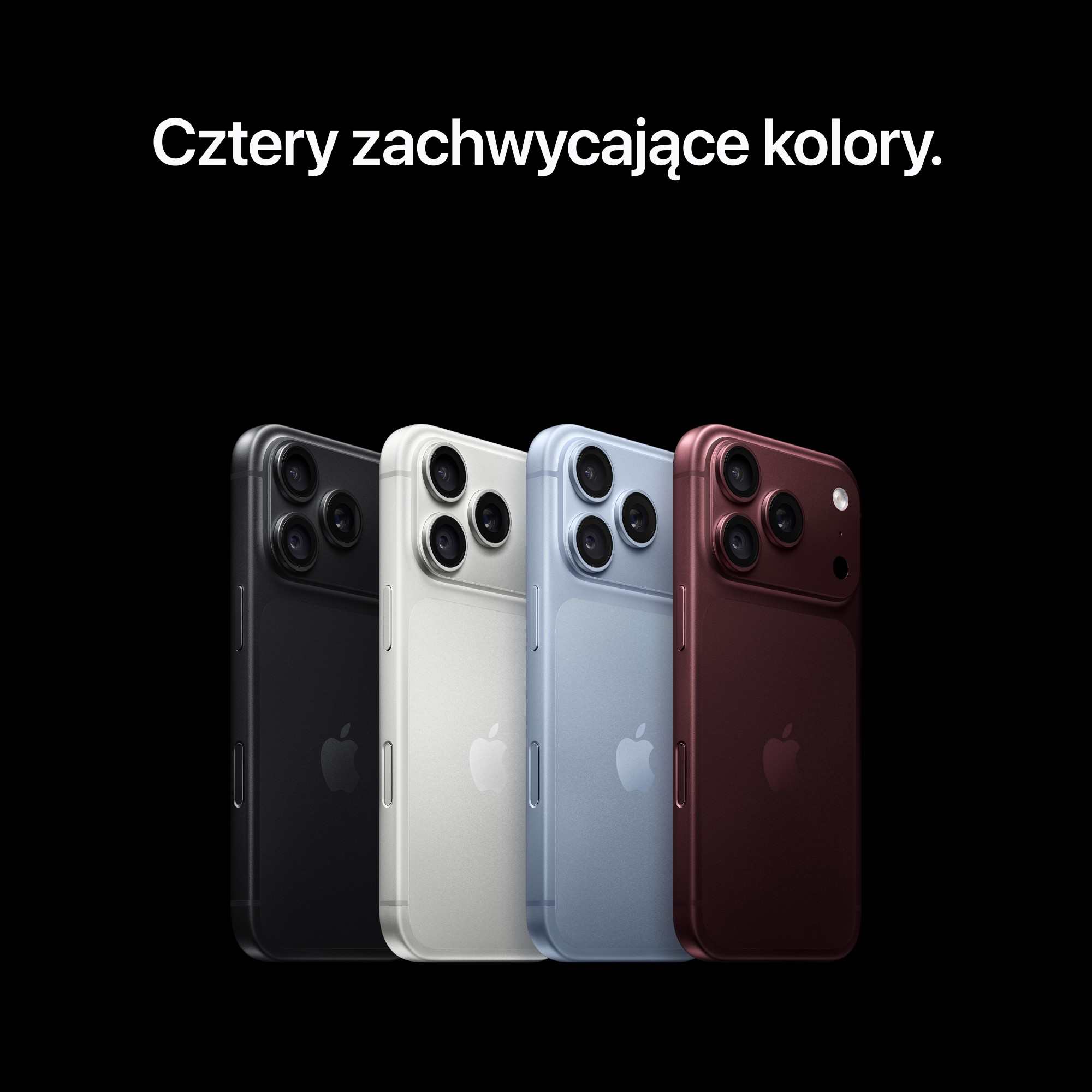Cztery smartfony w kolorze czarnym, białym, niebieskim i czerwonym na czarnym tle.