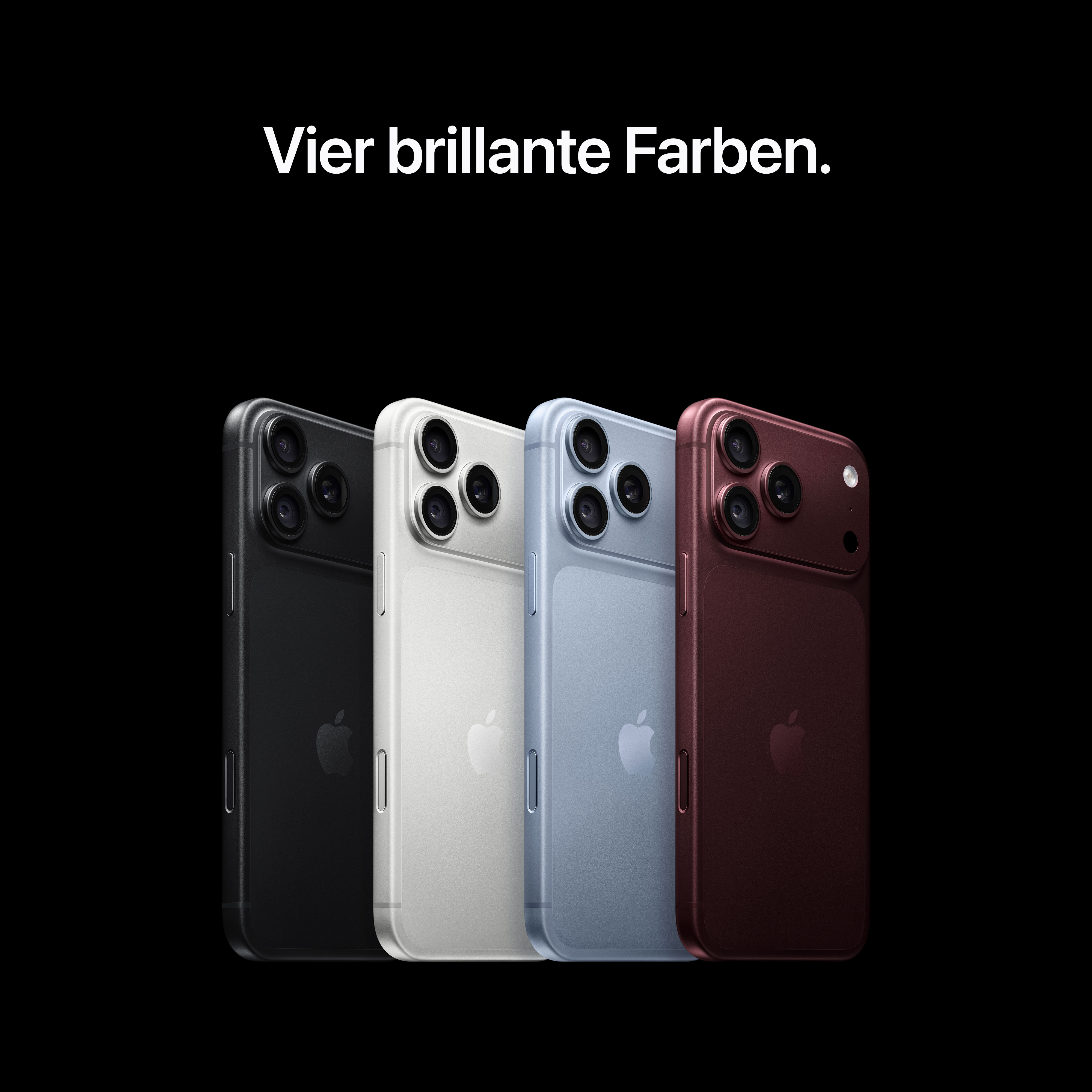 Vier Smartphones in Schwarz, Silber, Blau und Rot stehen nebeneinander vor schwarzem Hintergrund.