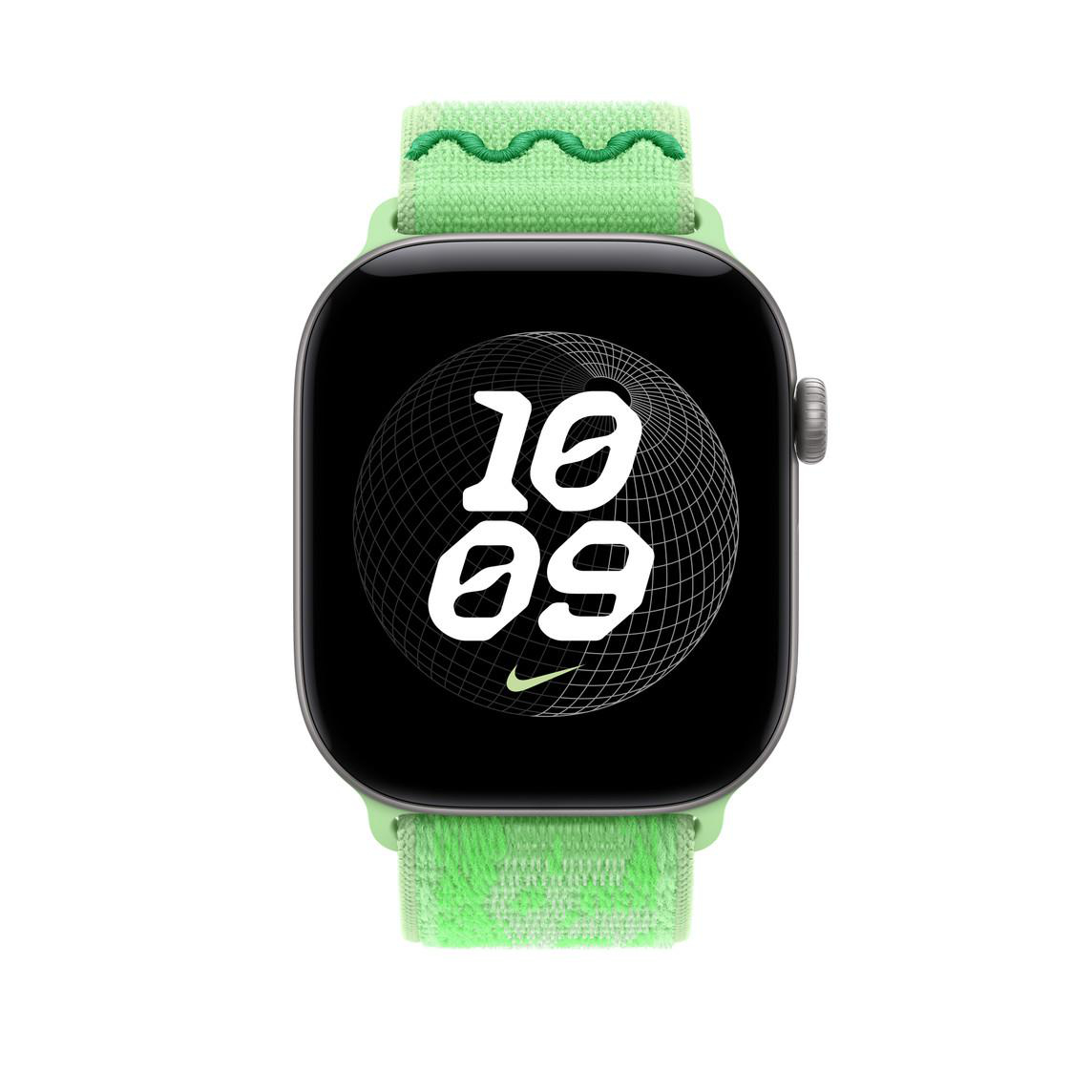 Eine Smartwatch mit grünem Textilarmband zeigt die Uhrzeit 10:09 und einen Drahtgitter-Globus auf schwarzem Bildschirm.