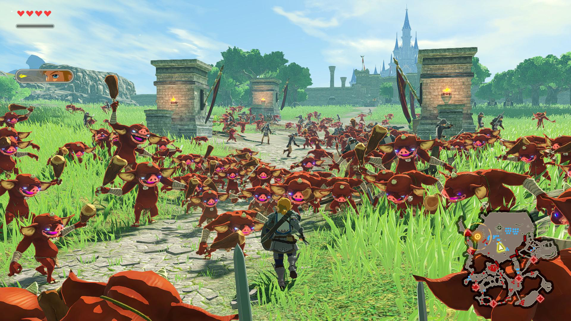 Link rennt auf einem Weg durch hohes Gras, umgeben von einer großen Horde roter Bokoblins vor einer Burg.