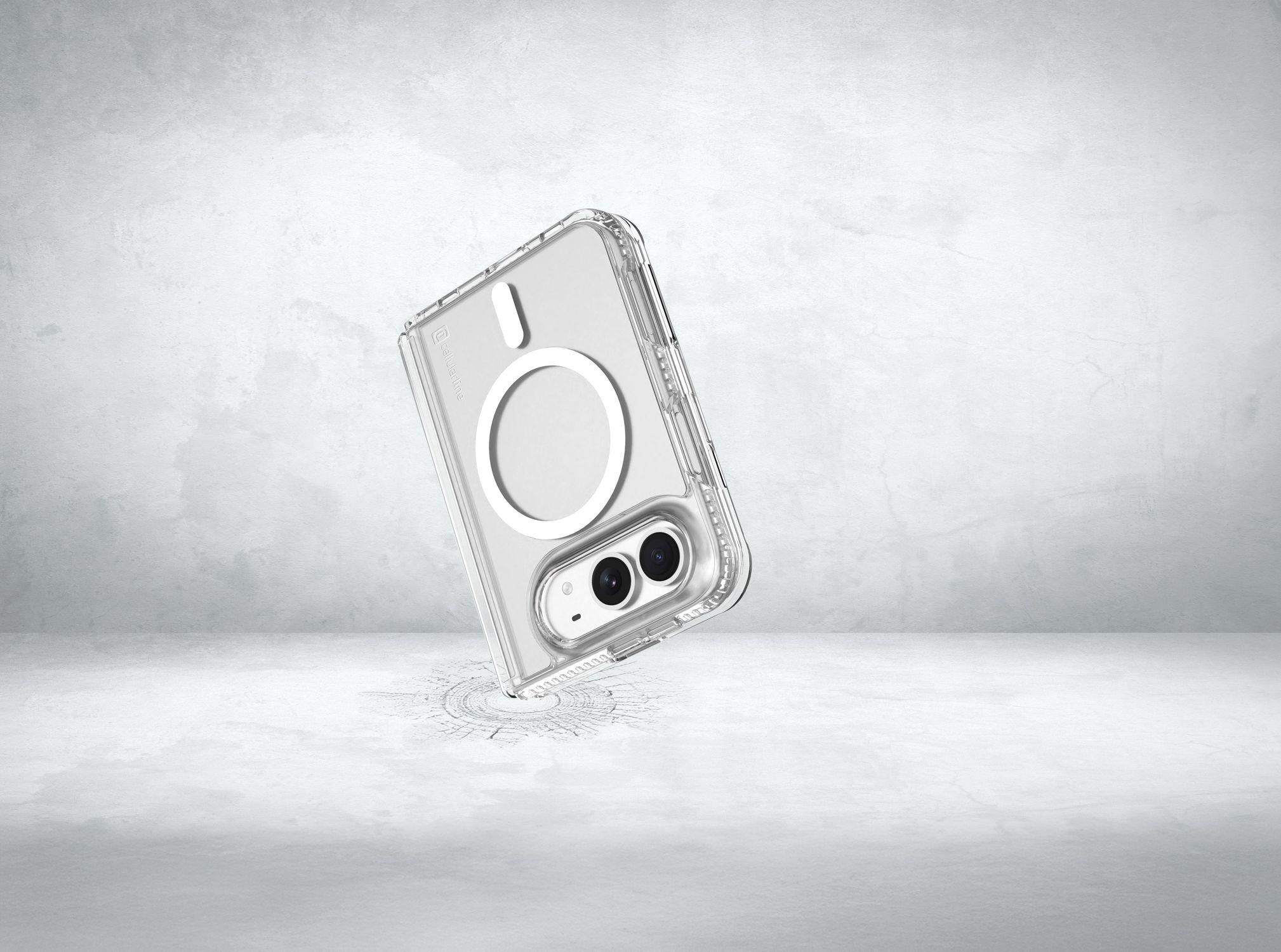 Eine transparente Schutzhülle für Smartphones schwebt über einer grauen Betonoberfläche und zeigt Kamera und Magnetring.