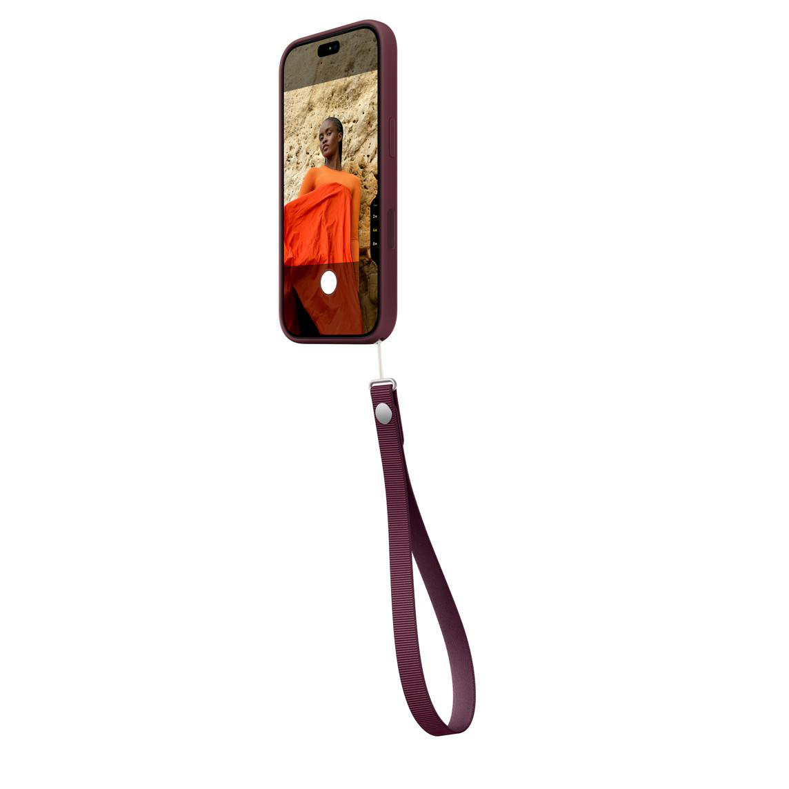 Ein Smartphone in lila Hülle mit passender Handschlaufe zeigt das Foto einer Person an einer strukturierten Wand.