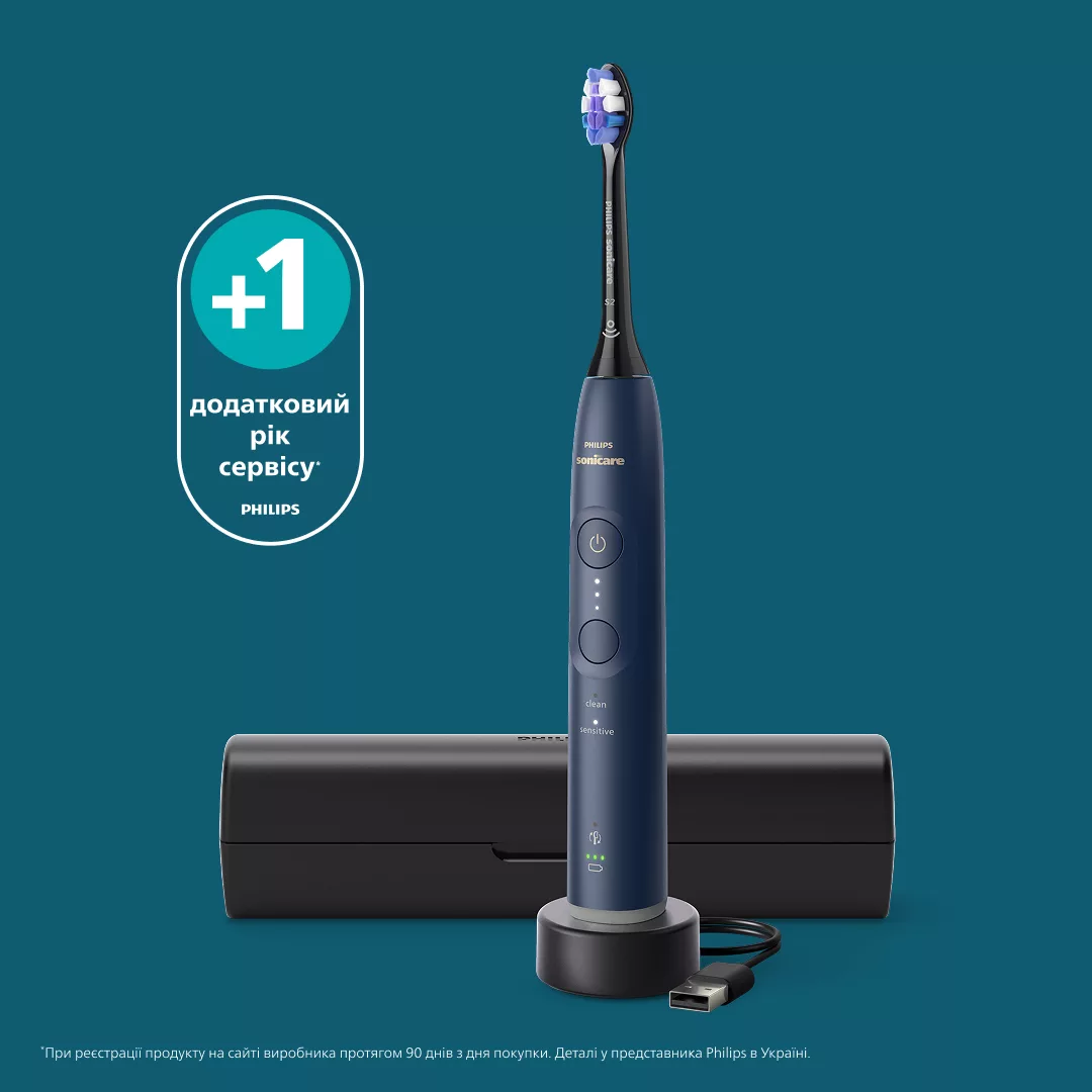 Blaue Philips Sonicare Zahnbürste auf Ladestation vor schwarzem Etui und grünem Hintergrund.