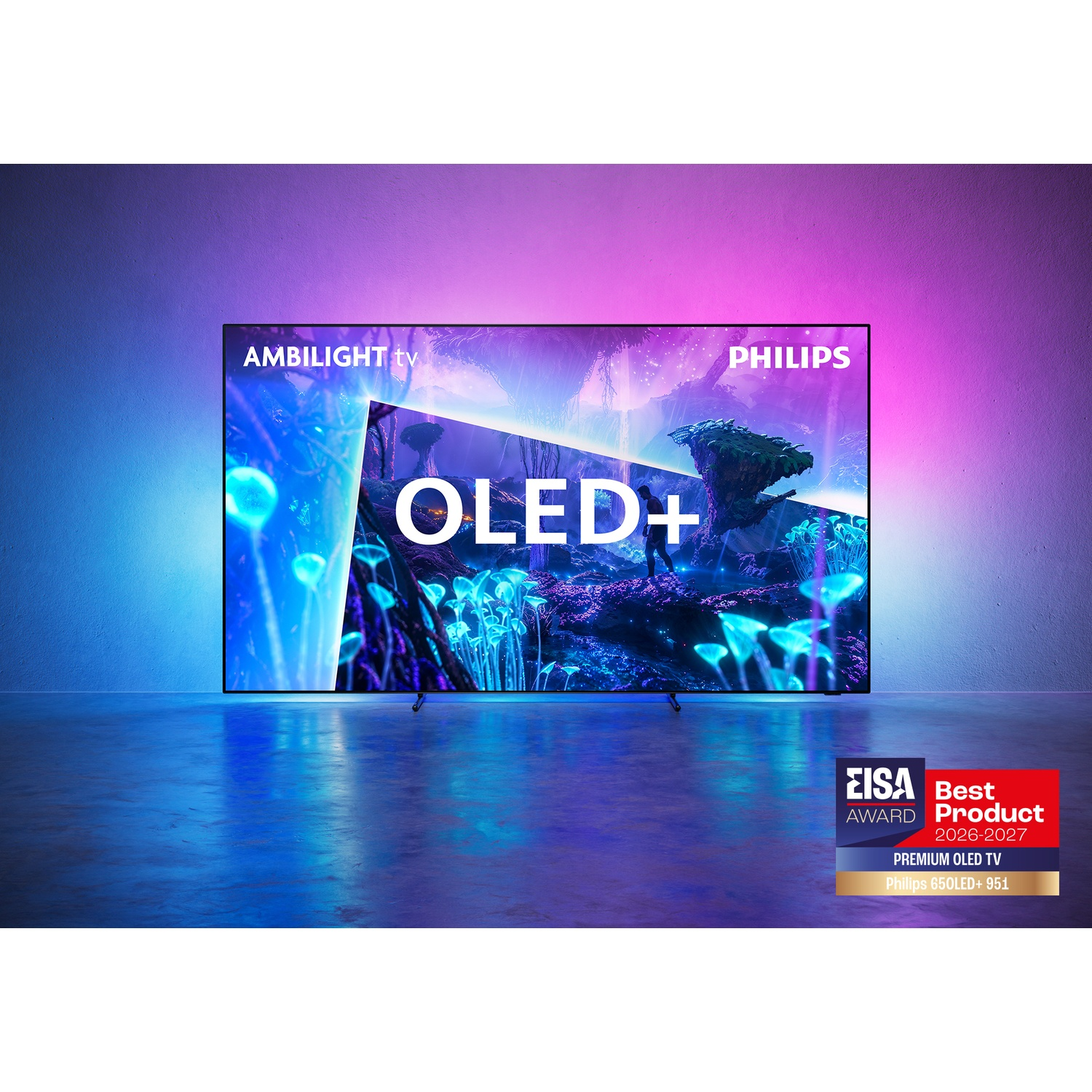 A Philips Ambilight OLED+ TV displays a vibrant alien landscape, casting colorful blue and pink light on a wall.