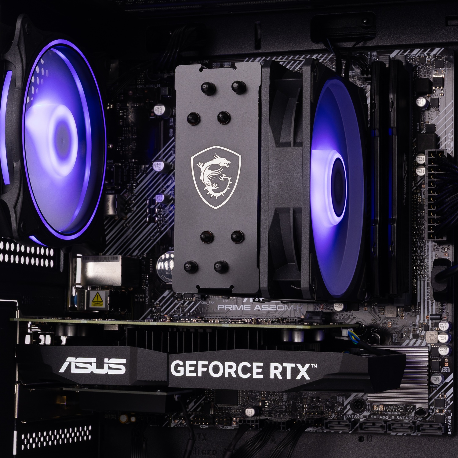 PC interior featuring an ASUS GeForce RTX graphics card, MSI CPU cooler, and two glowing fans.