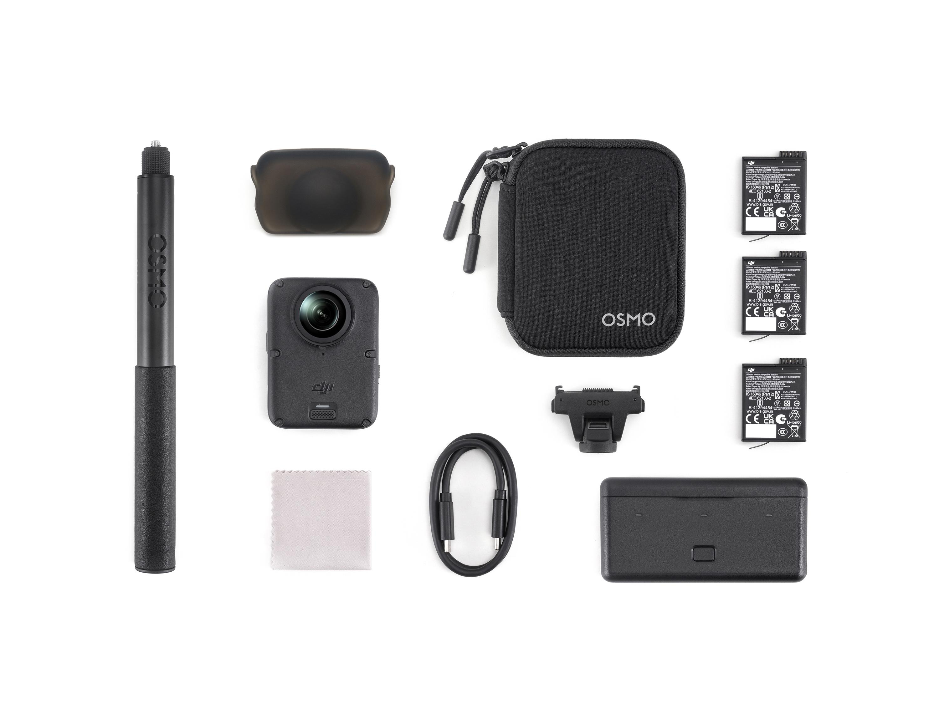 DJI Osmo Kamera mit Zubehör wie Griff, Batterien, Etui und Kabel auf weißem Grund.