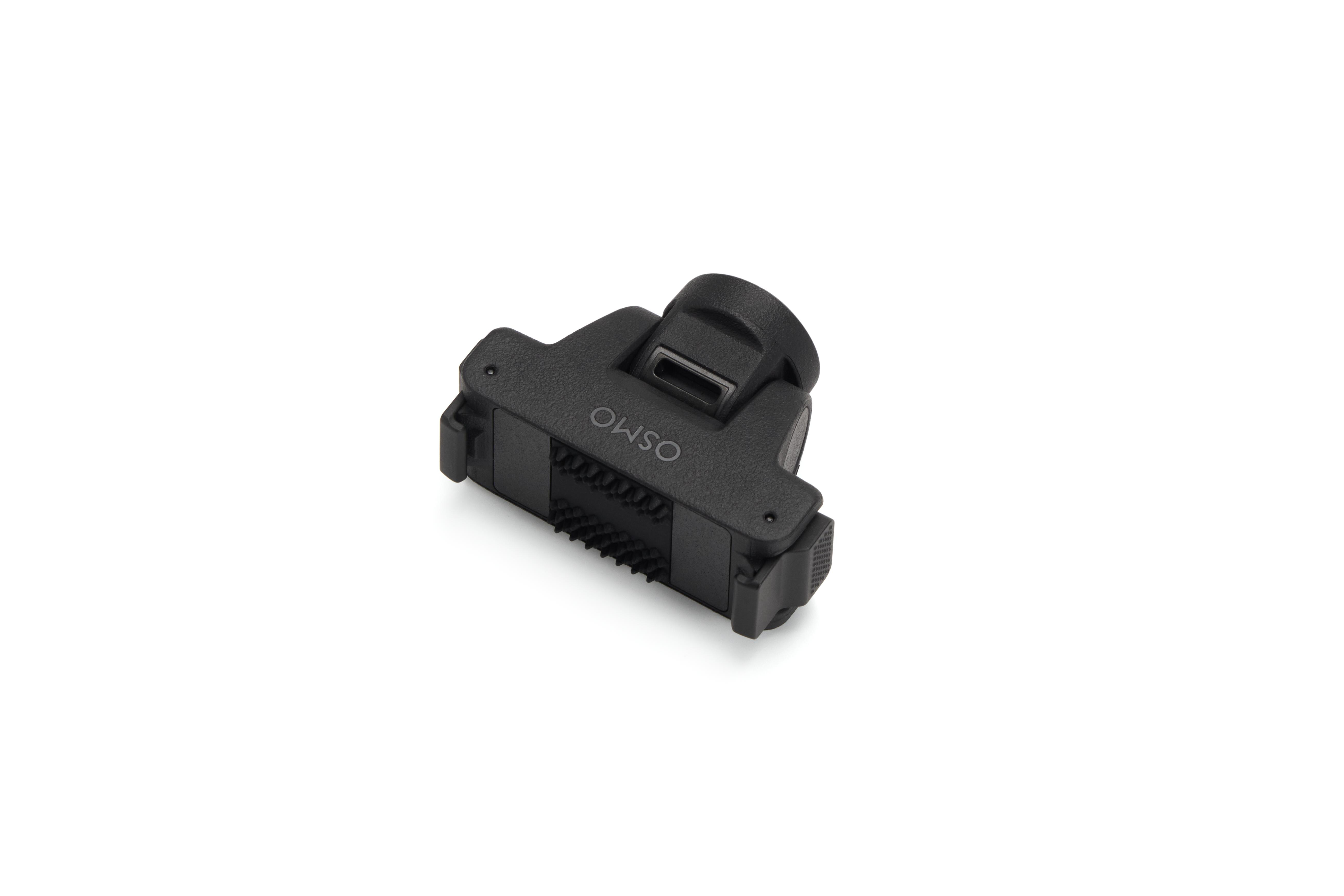 Ein schwarzes Osmo-Zubehörteil mit integrierten Bürsten und Clips auf weißem Hintergrund.