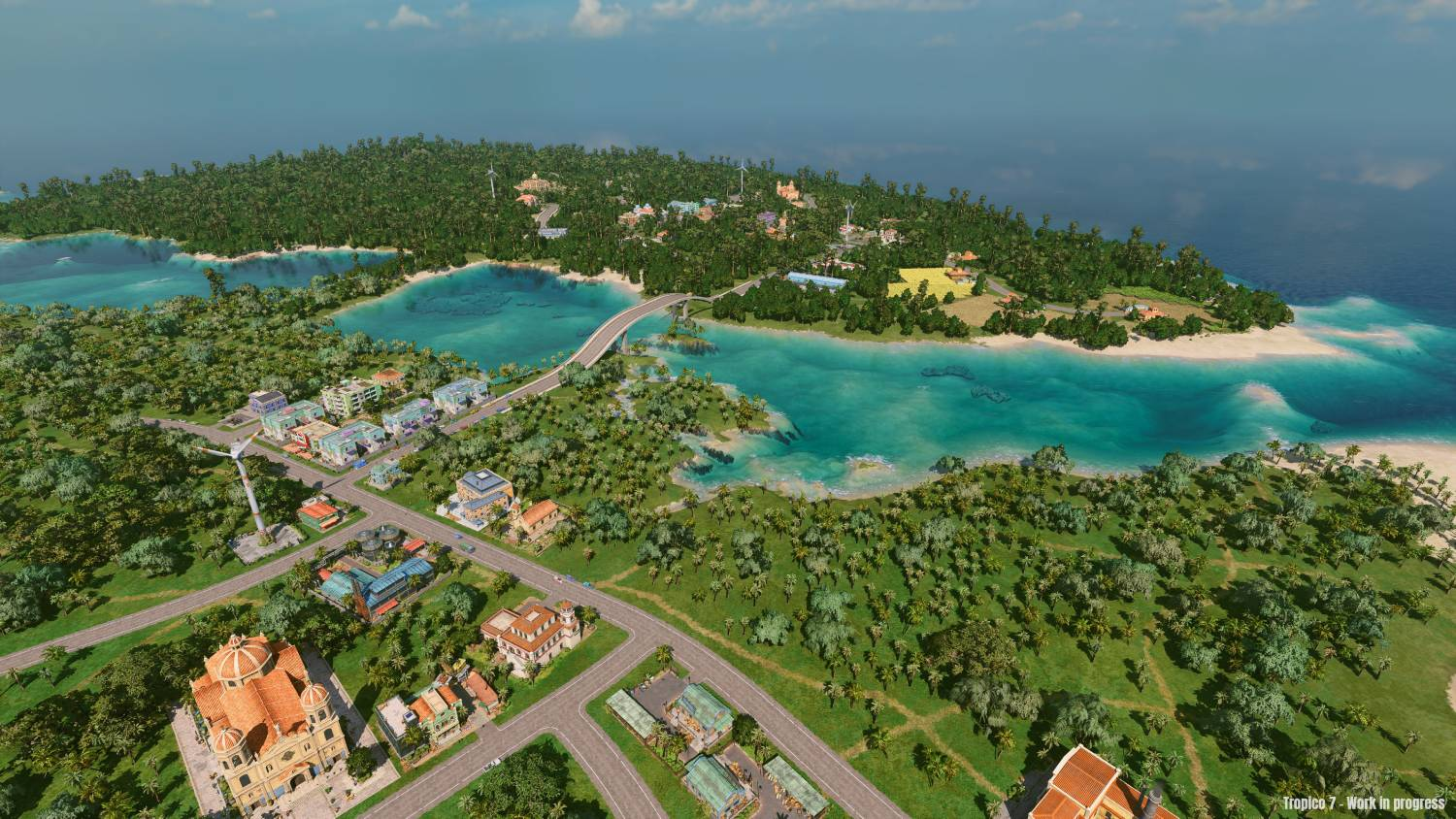 Vista de pájaro de una isla tropical con carreteras, edificios, puentes y agua azul clara.