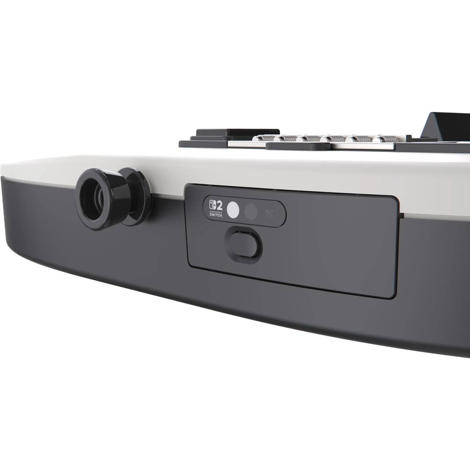 Vista lateral de un dispositivo en blanco y negro con interruptor para Nintendo Switch y PC y una perilla redonda.