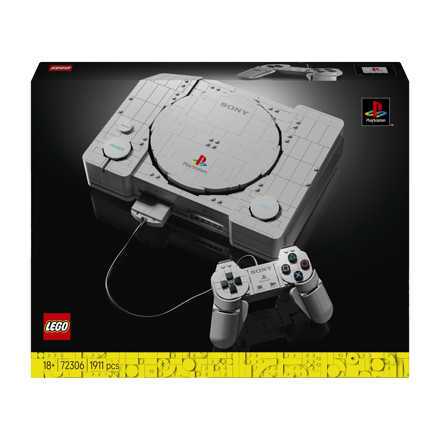 Replica Lego di una console PlayStation grigia con controller su sfondo nero.