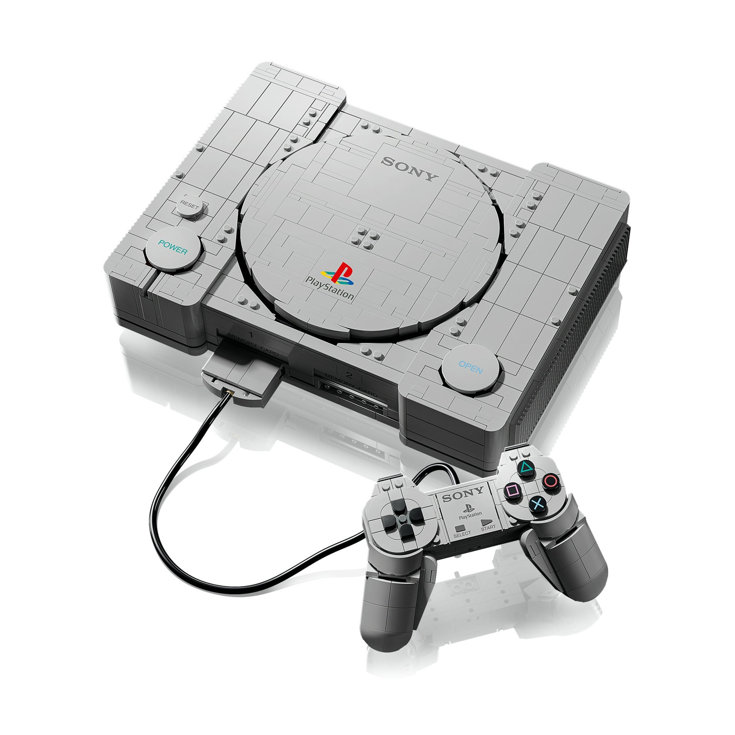 Una console di gioco grigia e un controller fatti di mattoncini Lego, su sfondo bianco.