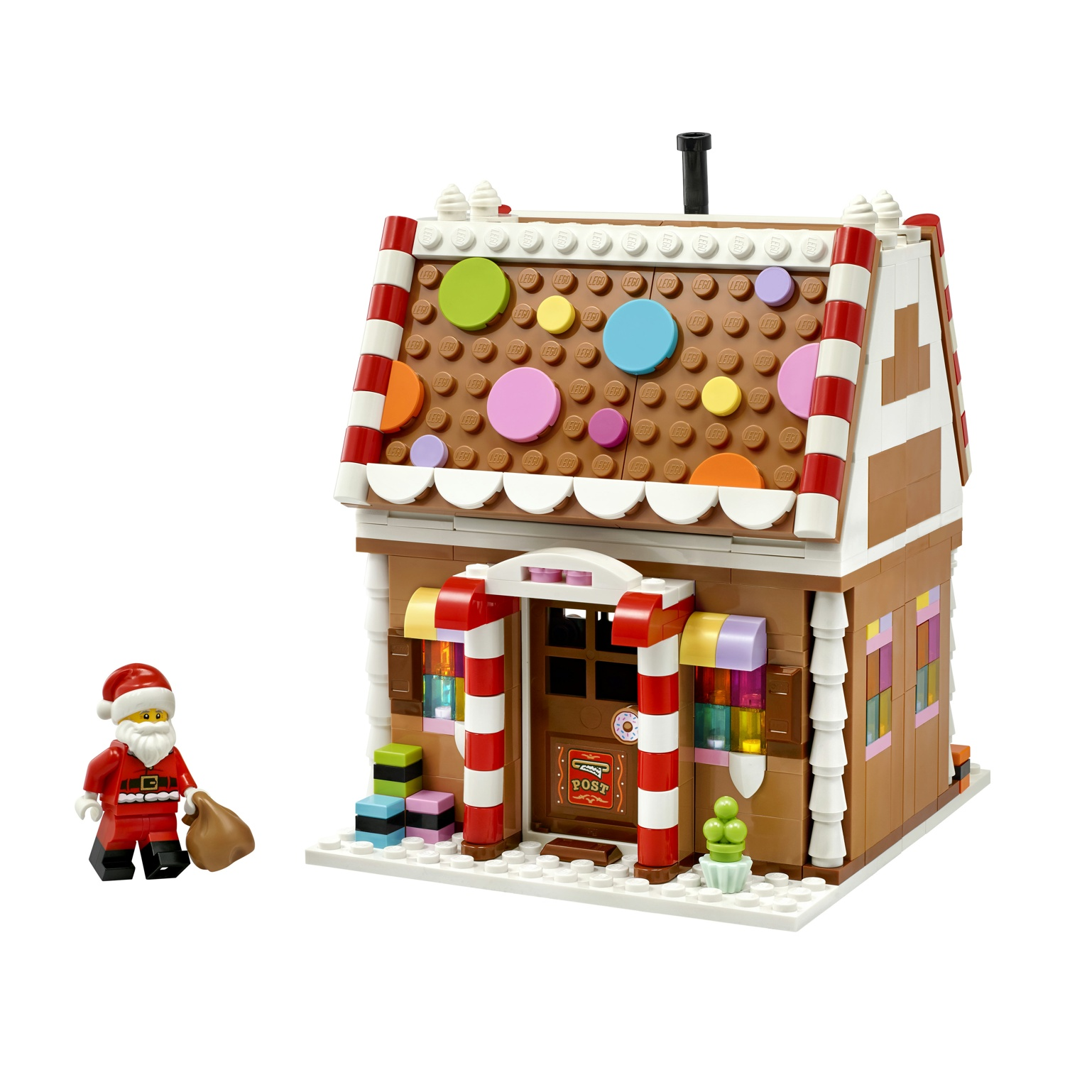 Una casa di marzapane Lego con decorazioni colorate e una minifigura di Babbo Natale.