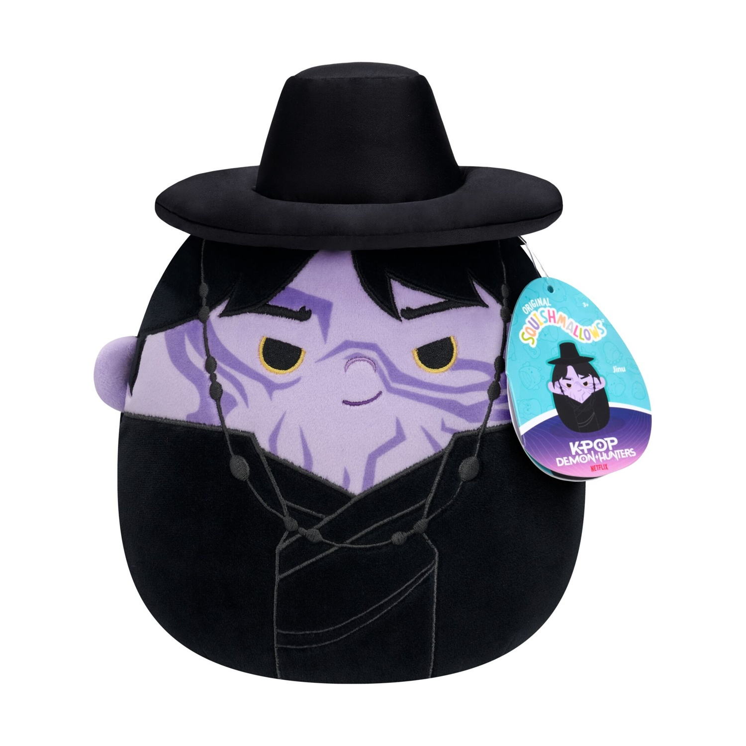 Peluche viola con cappello e tunica neri e un'etichetta blu.