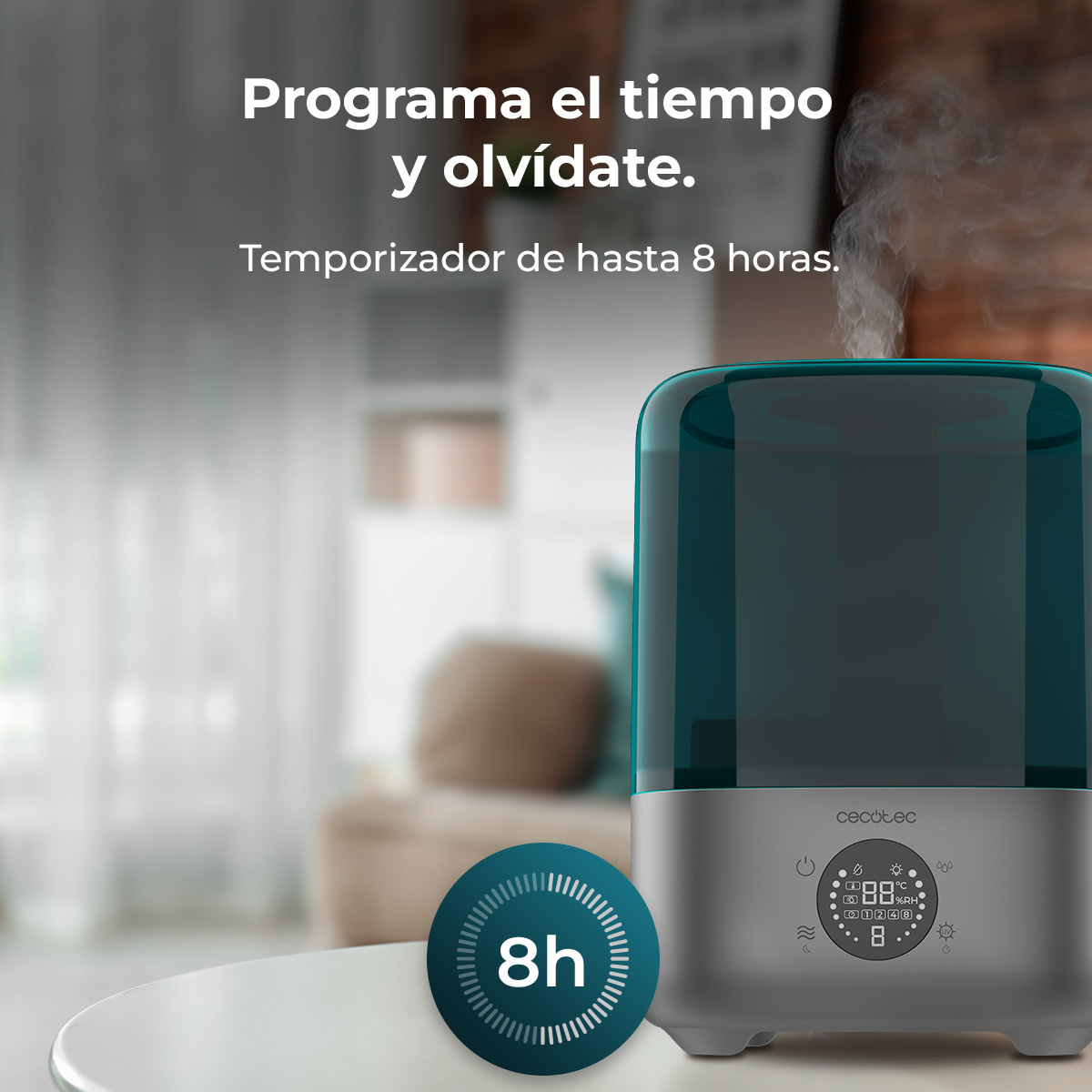 Un humidificador verde azulado y gris en una mesa blanca emite vapor, con texto en español arriba.