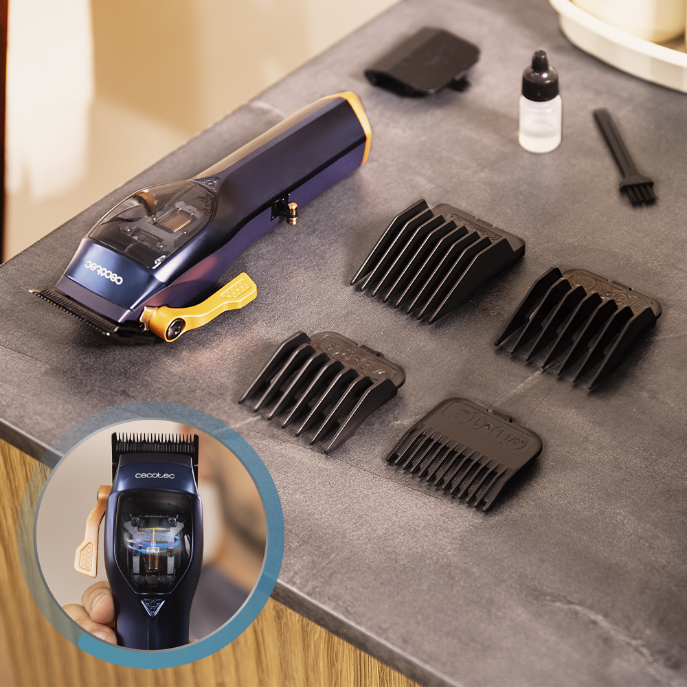 Cortapelos azul con accesorios que incluyen peines guía, aceite y cepillo en una encimera gris.