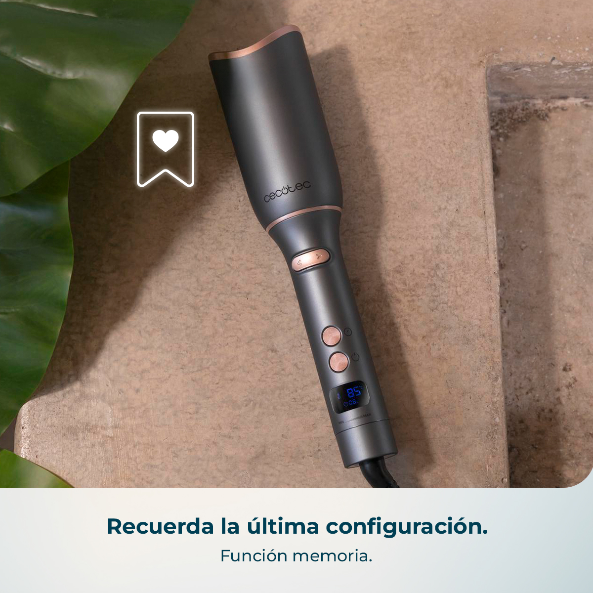 Rizador de pelo Cecotec gris oscuro con detalles en oro rosa, pantalla digital y botones en superficie de piedra.