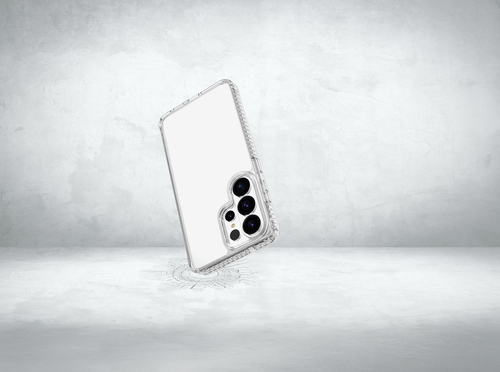Un smartphone con una funda protectora transparente flota sobre un suelo de hormigón claro.