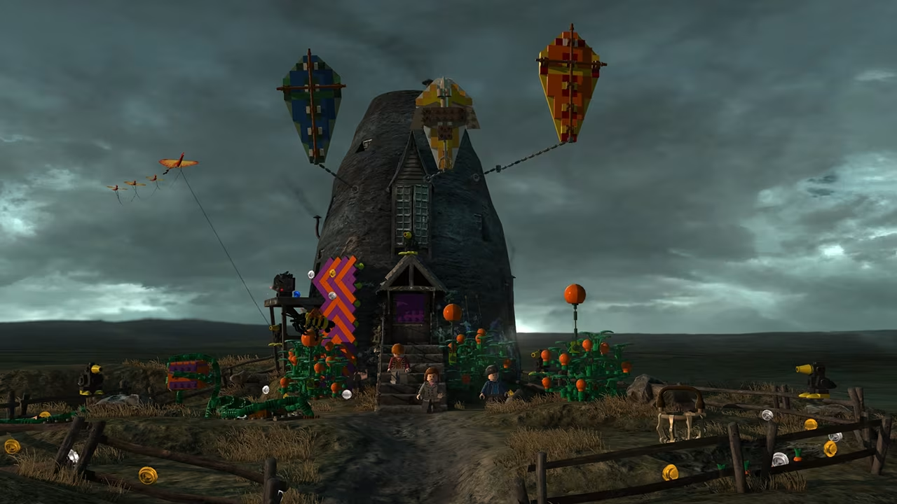 La cabane de Hagrid en Lego sous un ciel sombre avec des cerfs-volants et des personnages.