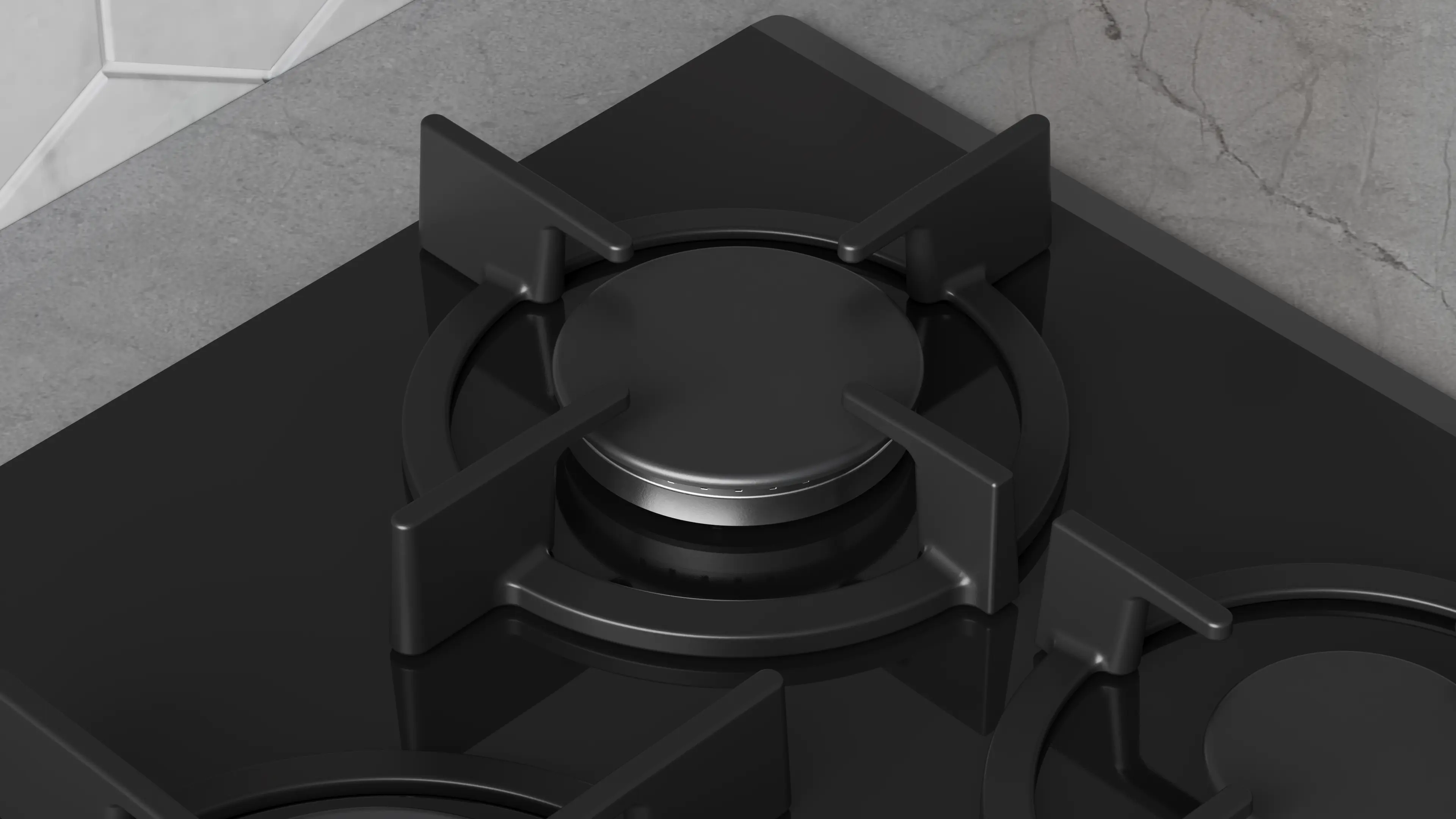Primer plano de una cocina de gas negra y moderna con superficie de vidrio brillante sobre una encimera gris.