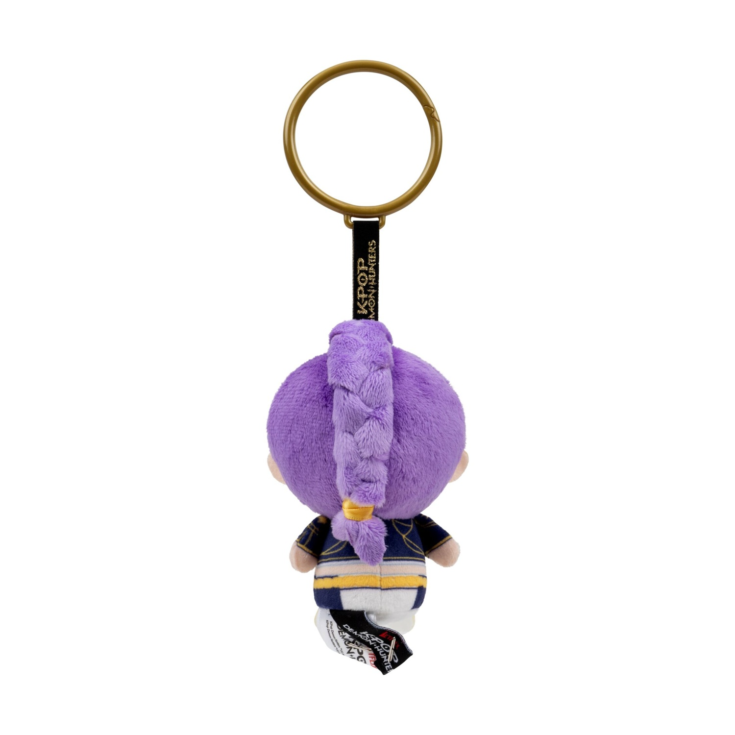 Vista posteriore di un portachiavi in peluche con capelli viola trecciati, anello dorato e vestiti blu e oro su sfondo bianco.