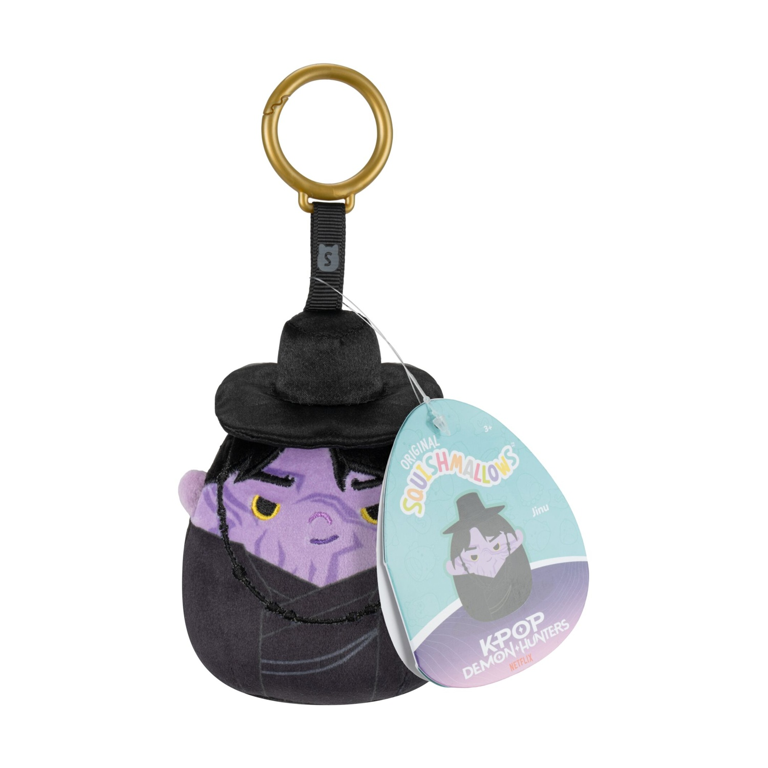 Un portachiavi in peluche Squishmallows con viso viola, cappello nero ed etichetta su sfondo bianco.
