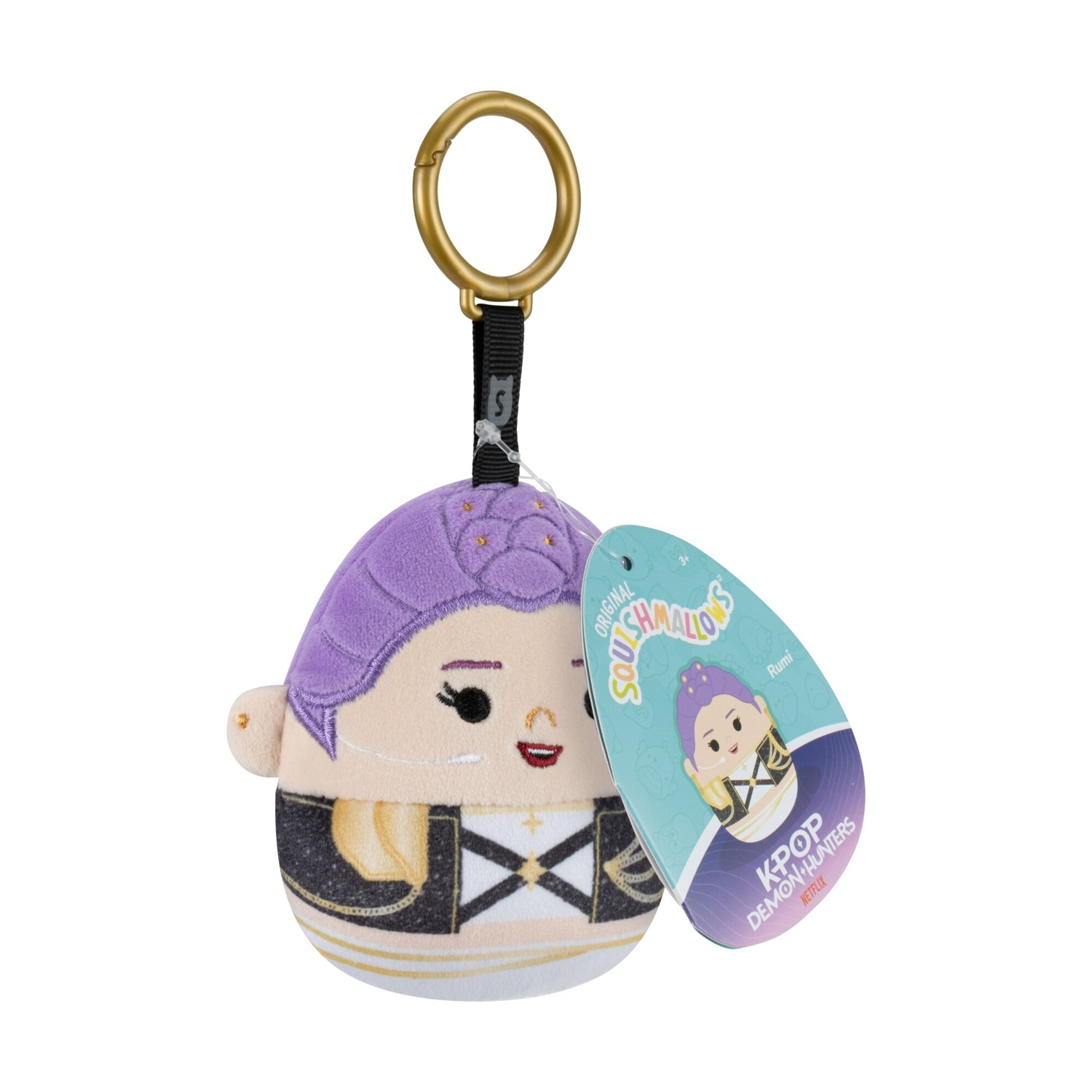Un portachiavi di peluche Squishmallows con capelli viola e abito di scena, attaccato a un anello dorato.