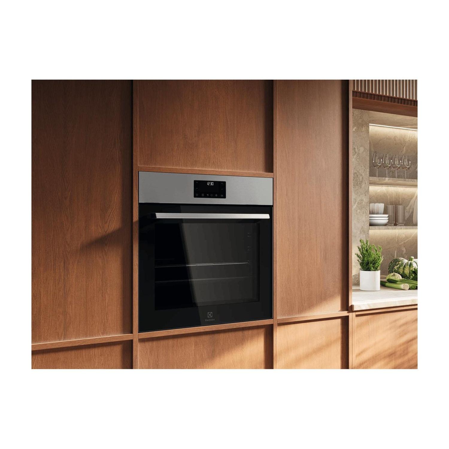 Un forno moderno con pannello in acciaio integrato nei mobili in legno di una cucina.