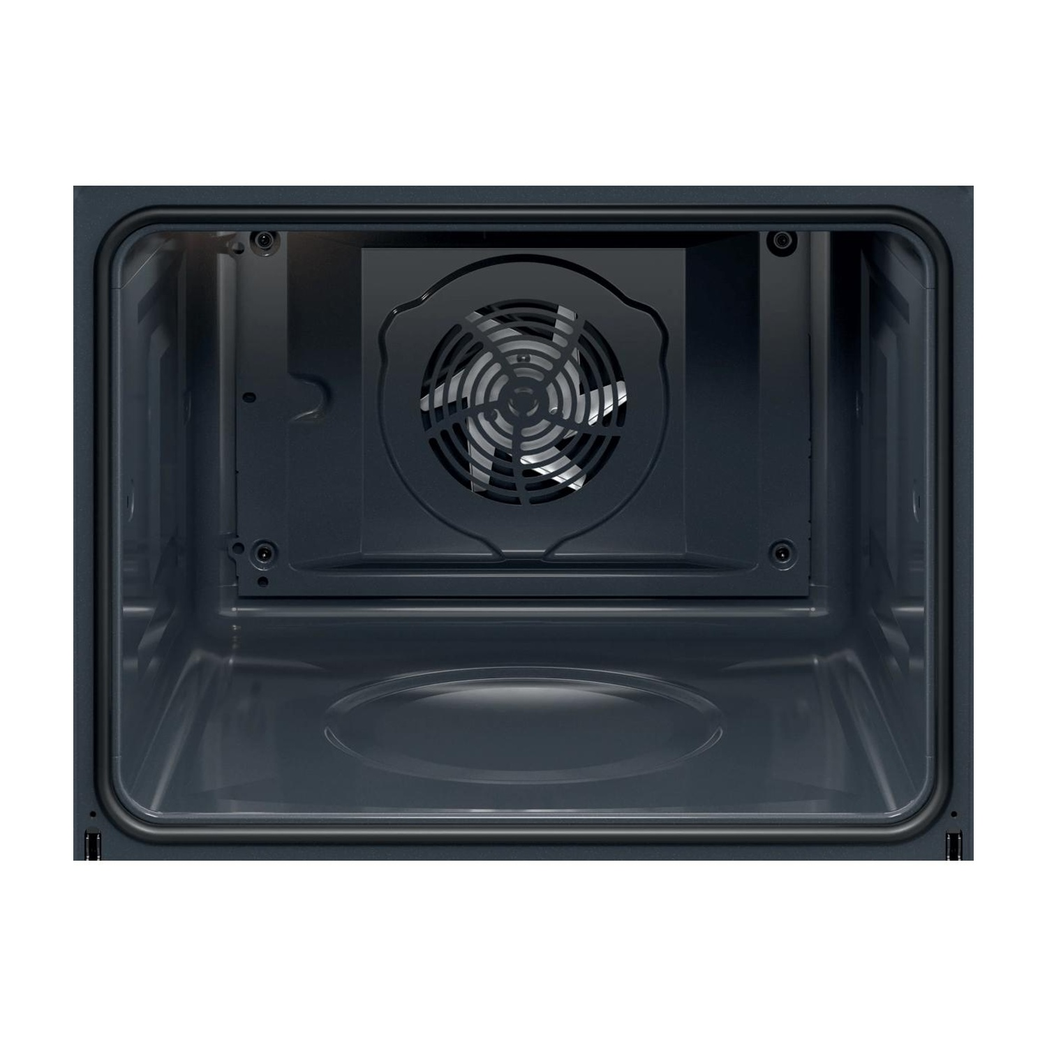 L'interno di un forno scuro con una ventola circolare e una superficie inferiore liscia.