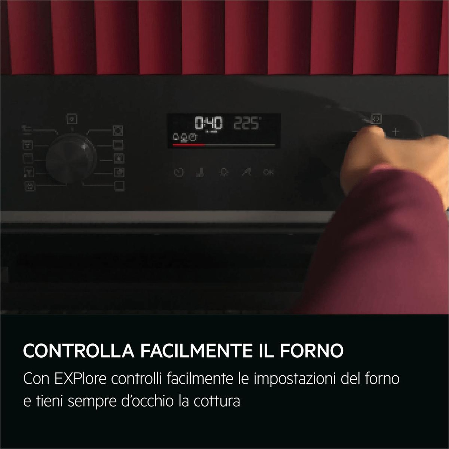 Mano che aziona il pannello di controllo digitale di un moderno forno nero su fondo rosso.
