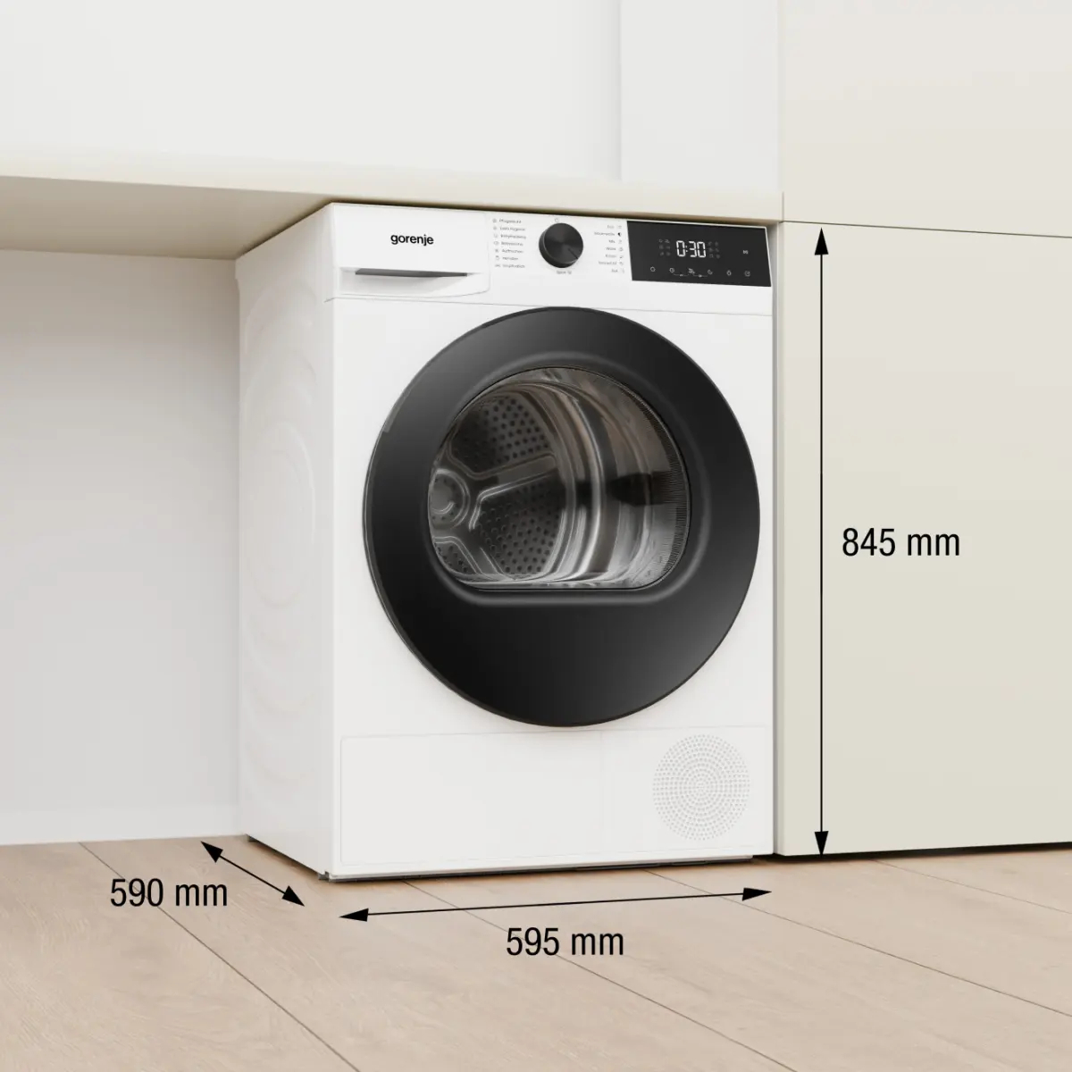 Weißer Gorenje Trockner mit schwarzer Tür, integriert in Küchenmöbel, Maße angegeben.