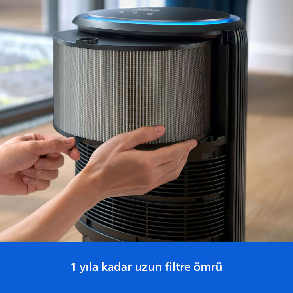 Mavi ışıklı siyah bir hava temizleyicinin silindirik filtresini çıkaran veya takan eller.