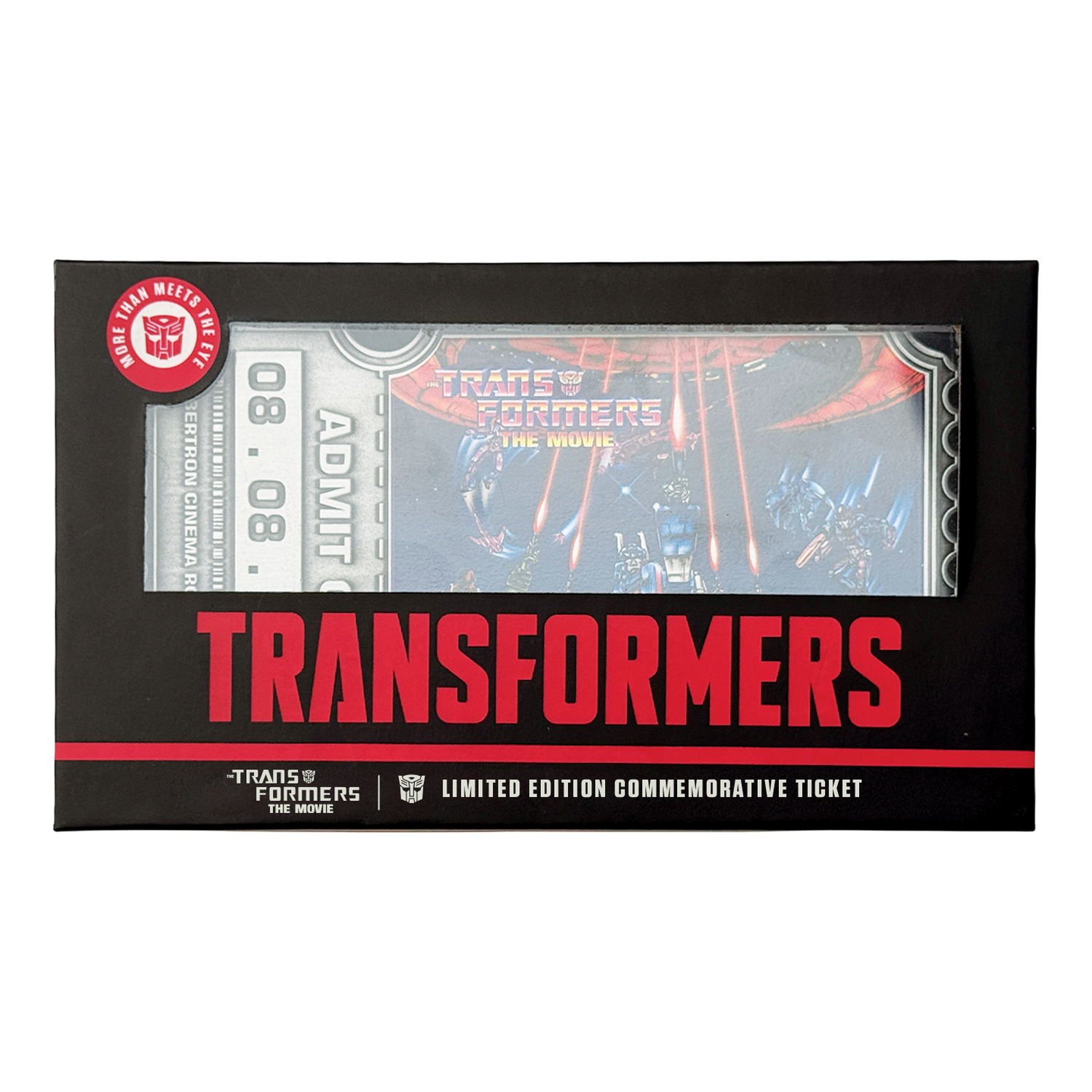 Una caja negra con una entrada conmemorativa de Transformers The Movie, detalles rojos y texto blanco.