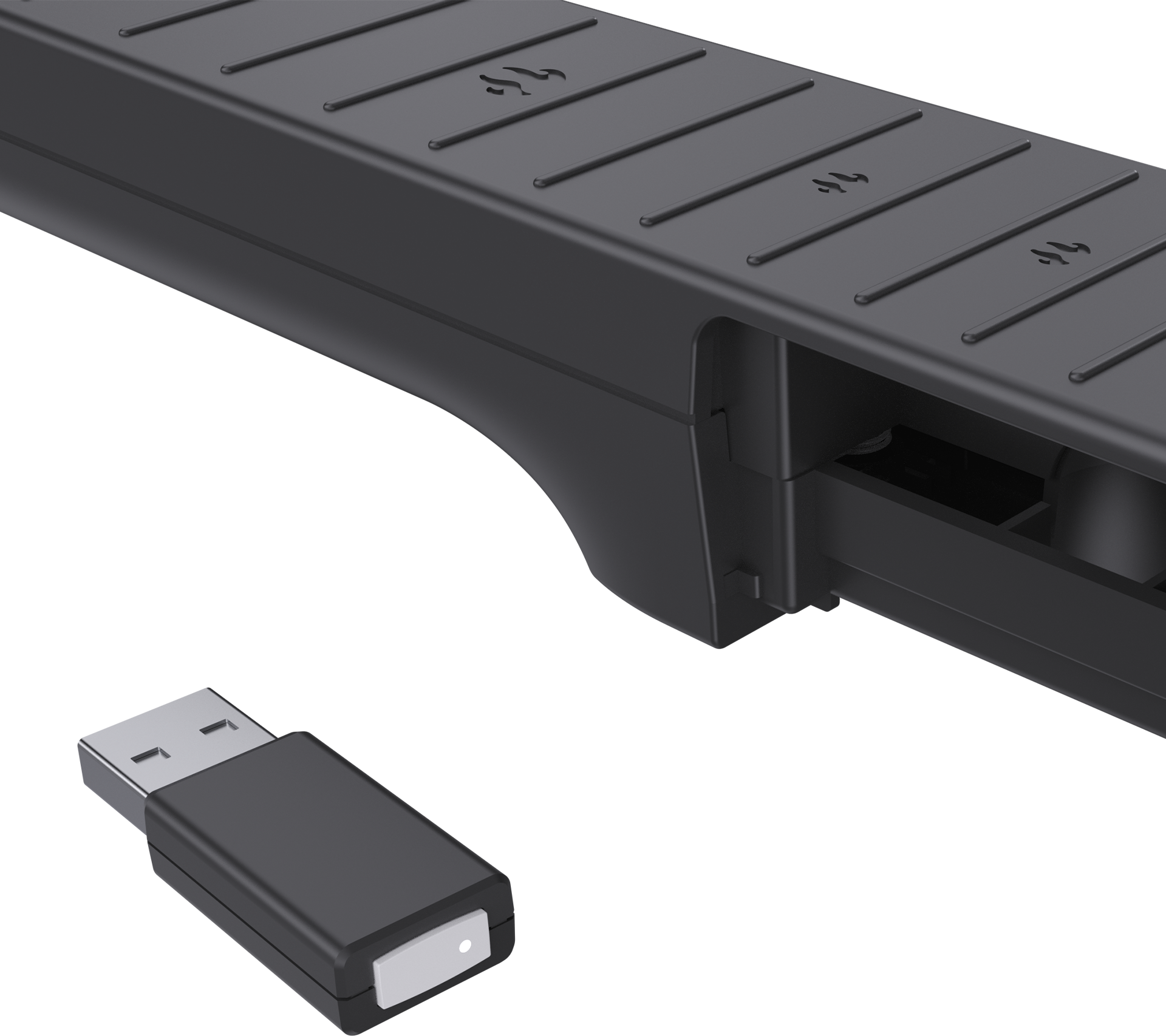 Ein schwarzer USB-Empfänger liegt vor einer dunklen, gerippten Leiste.